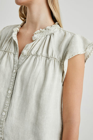 Ruthie Top with Flutter Cap Sleeves, a Ruffled Banded Collar, Buttons Down the Front, and Soft Shirring at Front Yoke in Sage Acid Wash Colorway - Front View Featured on Model