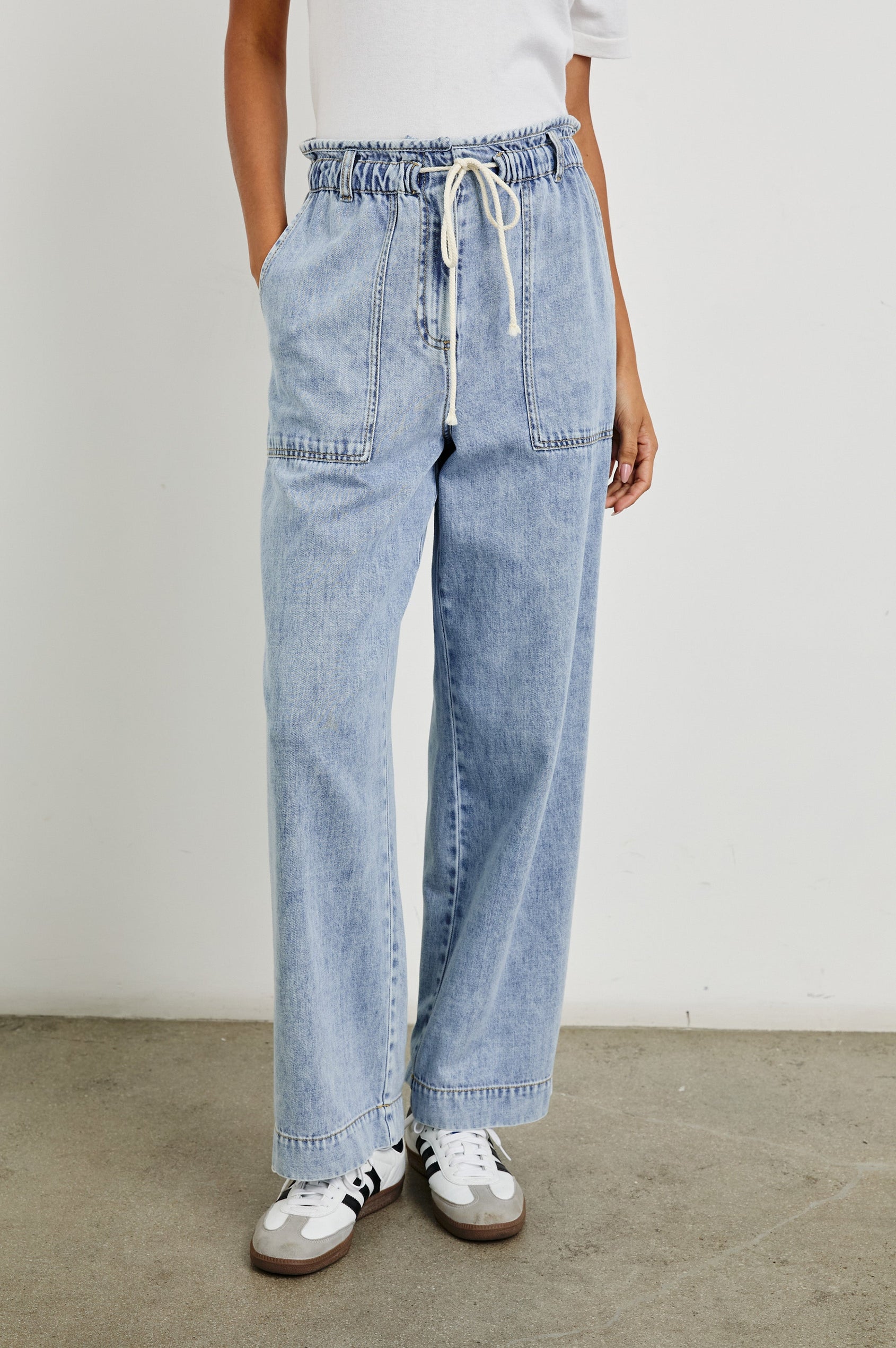Ryan high rise linen pant with shirred waist and drawstring in light wash Faded Indigo- front view on model, hand in pocket