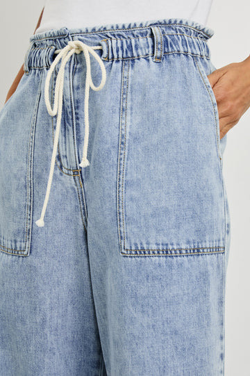 Ryan high rise linen pant with shirred waist and drawstring in light wash Faded Indigo- close up of details on model