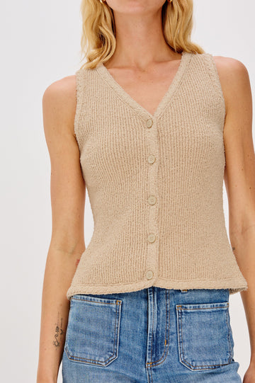 Soft cotton vest in a neutral Oat Colorway. The vest features subtle ribbing, a full-button front, and is styled on its own for a clean, minimalist look. Close up of details featured on model.