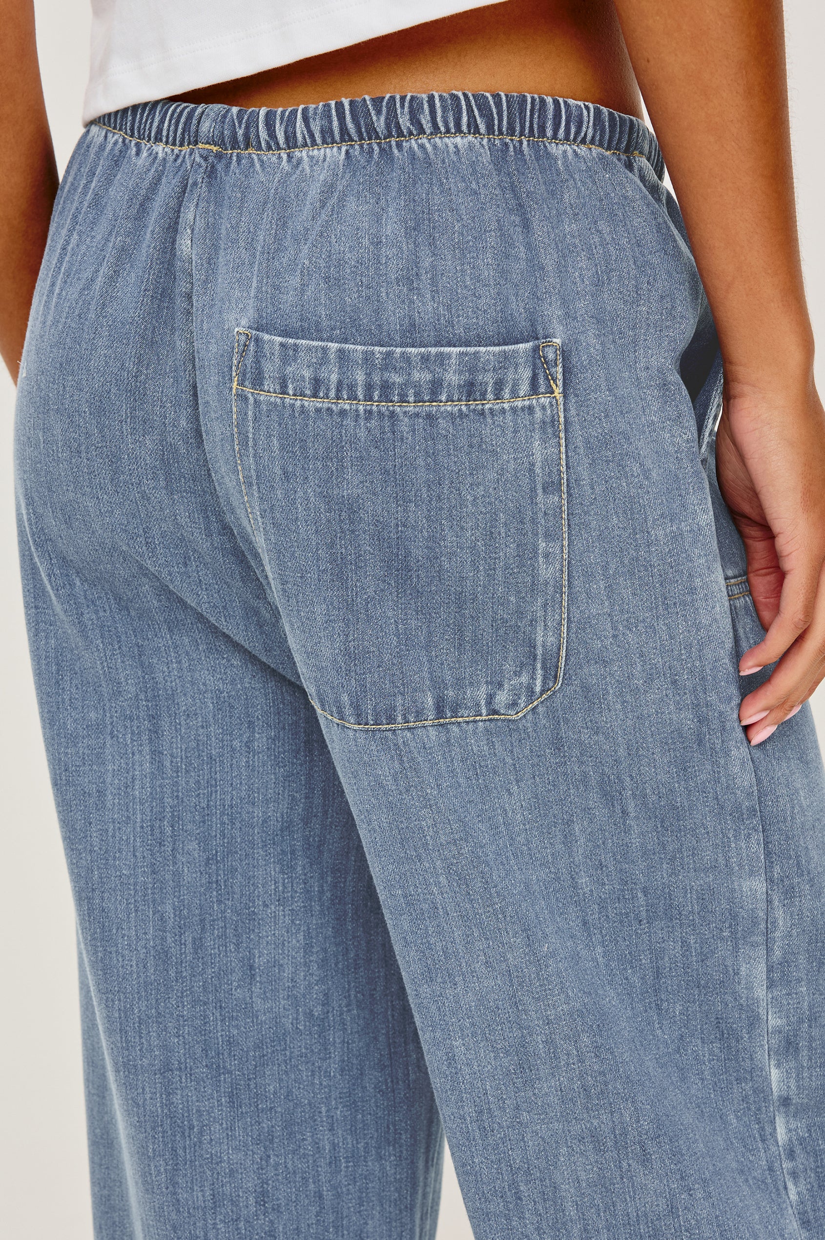 Sanderson Pant in Cotton Lyocell Denim With Relaxed Fit, Drawstring Waist Tie, Side Pockets, and Carpenter-Style Leg Panels in Antique Blue Colorway - Lower Body Close Up Back View Featured on Model