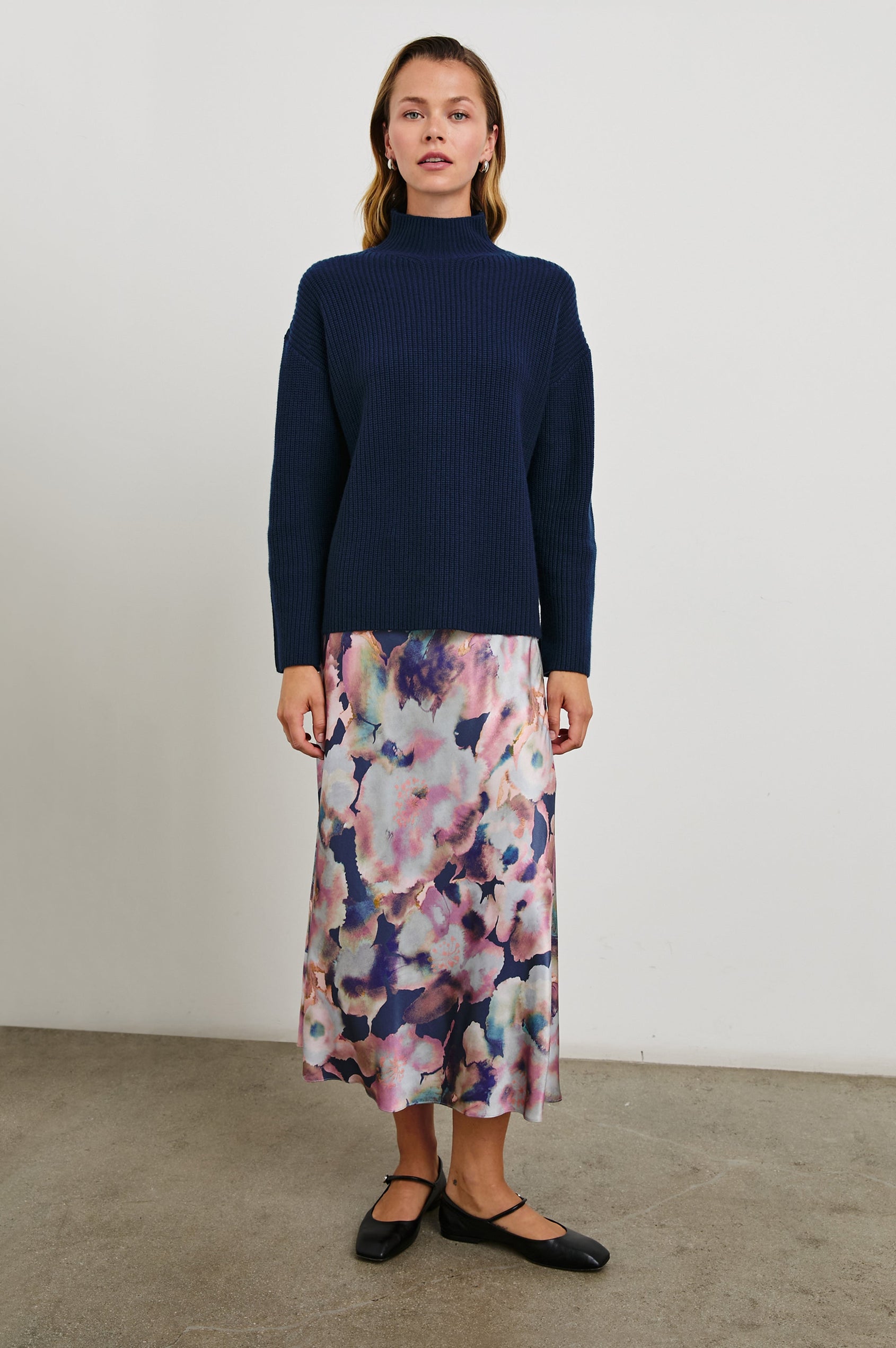 Sanna Long Sleeve Knit Sweater with a Funnel Neck and Slits at the Back of the Neck and on the Cuffs in Dark Slate Colorway - Front Full Body View Featured on Model