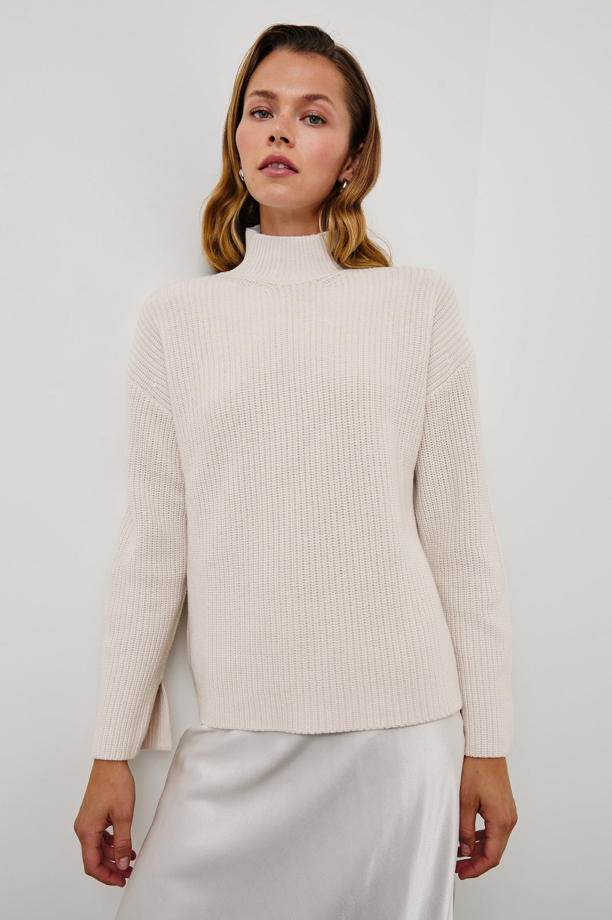 Sanna Long Sleeve Knit Sweater with a Funnel Neck and Slits at the Back of the Neck and on the Cuffs in Hazy Dust Colorway - Front View Featured on Model