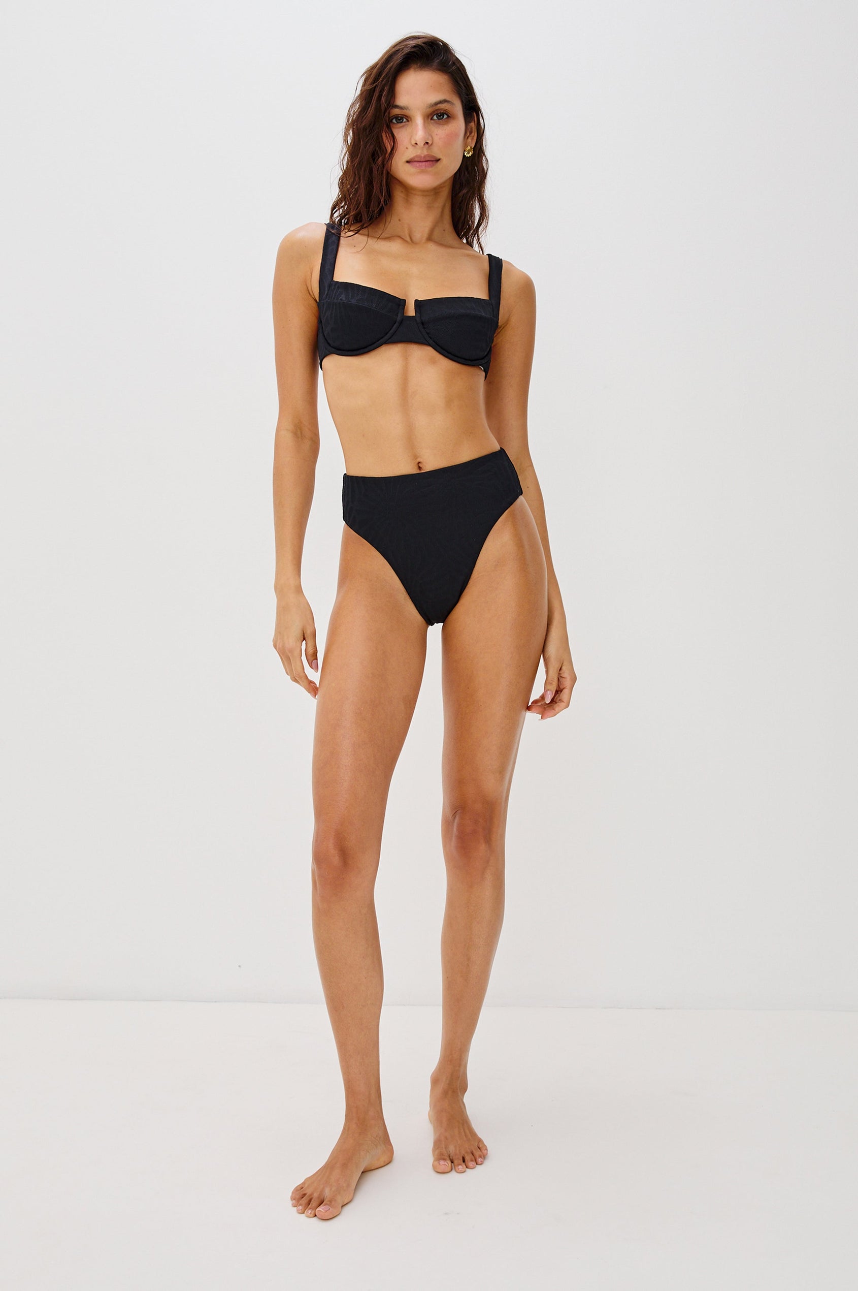 Savannah High Waist Bikini Bottom with Classic Coverage and Fossils Texture in Black Colorway. Full Body Front View Shown on Model.