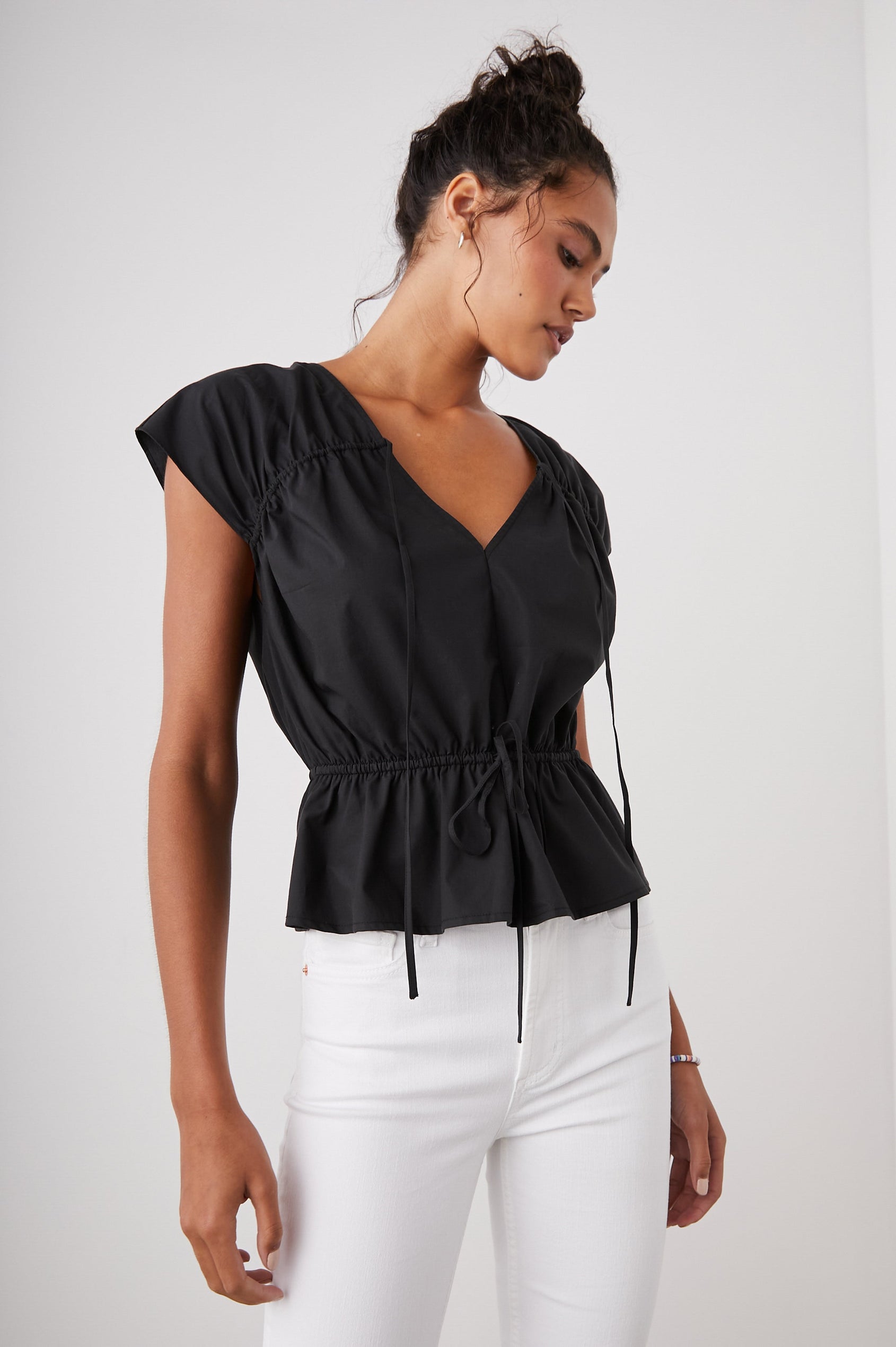 Savi Short-Sleeve Top with a V Neck, Cap Sleeves, a Drawstring From Each Sleeve Shoulder to the Neckline and a Drawstring at the Waist in Black Colorway - Front View Featured on Model 