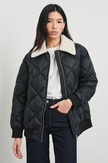 Shay Quilted Jacket with Zip Closure and a Cream Sherpa Collar in Black Colorway - Front View Featured on Model 