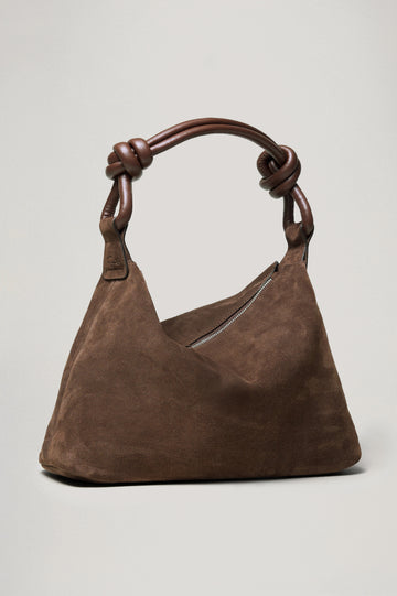 The Siena is a true slouchy hobo bag, crafted from smooth leather with a knotted top strap and a zip closure finished with a fringed tassel. In Espresso Suede Colorway. Front view featured.