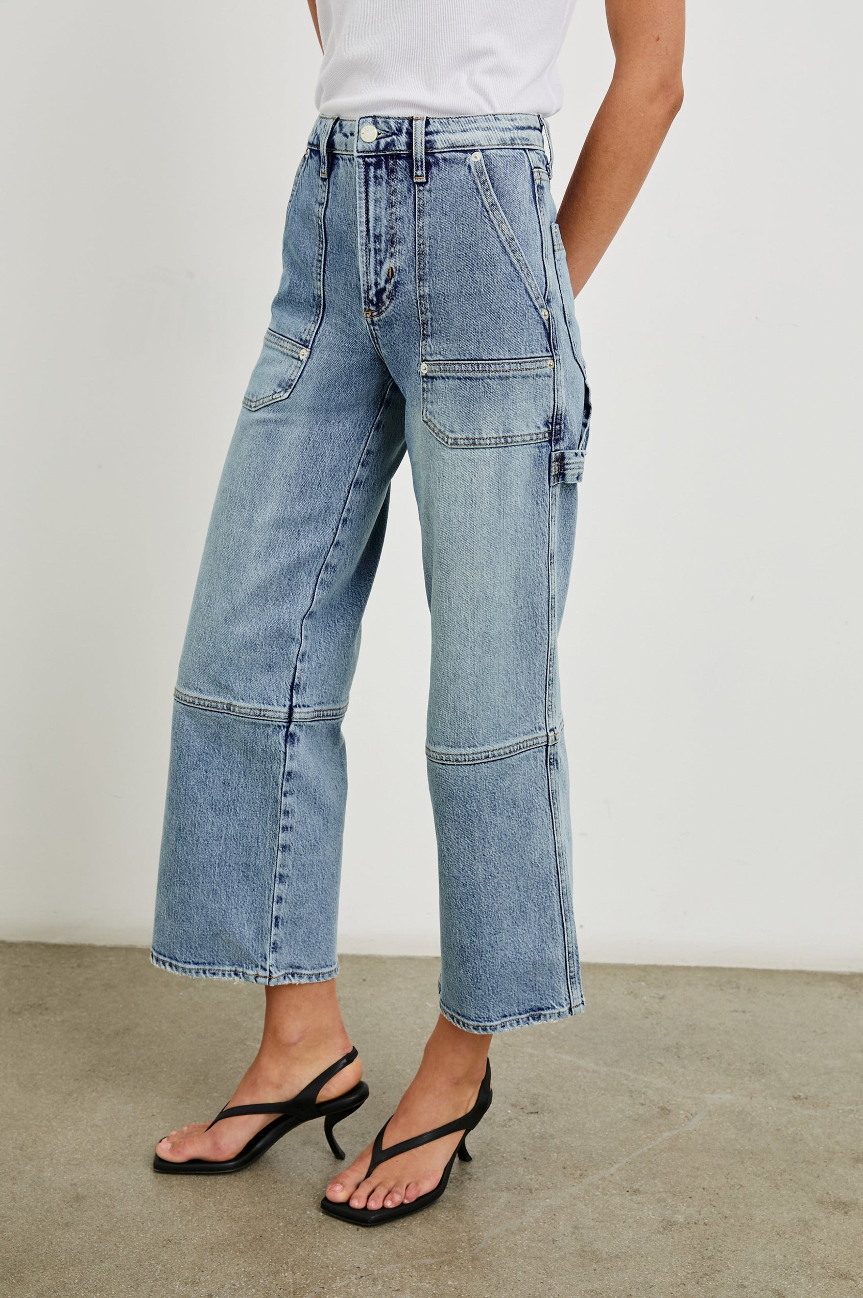 Silverado high rise wide leg crop pant with carpenter style details and contrast stitching in Blueprint - front slight angle view on model