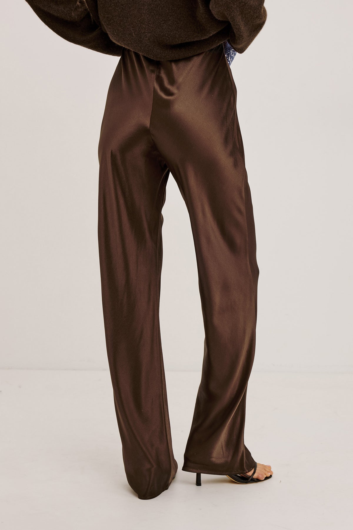Silvi High-Waisted Pant in Metallic Satin Back Crepe With Elastic Waistband and Straight Legs in Espresso Colorway - Upper Body Back View Featured on Model.