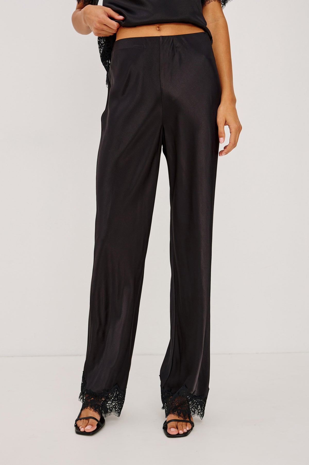 Silvi Pant in Satin-Back Crepe With Straight Legs, Elastic Waist, and Lace Hem in Black Colorway - Front Crop View Featured on Model.