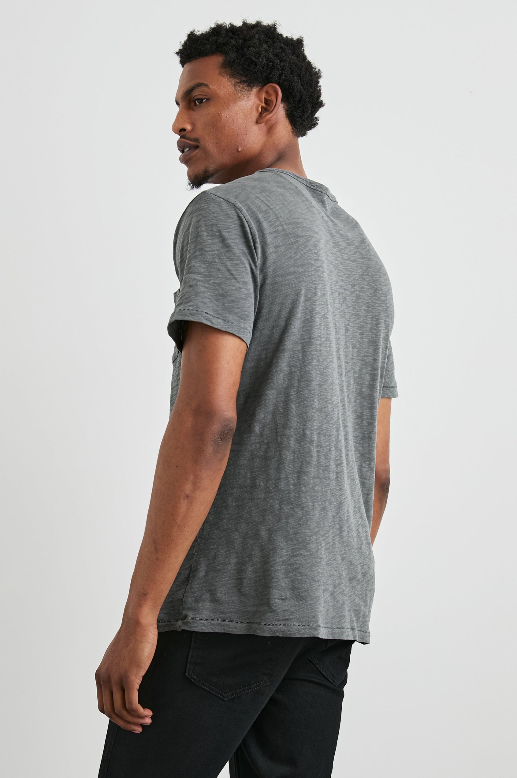 Skipper Short-Sleeve T-shirt with a Crew Neck and a Chest Patch Pocket in Washed Black Colorway - Side View Featured on Model