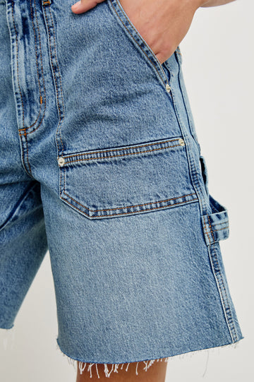 Slater high rise bermuda short with carpenter style details in Blueprint - front view on model