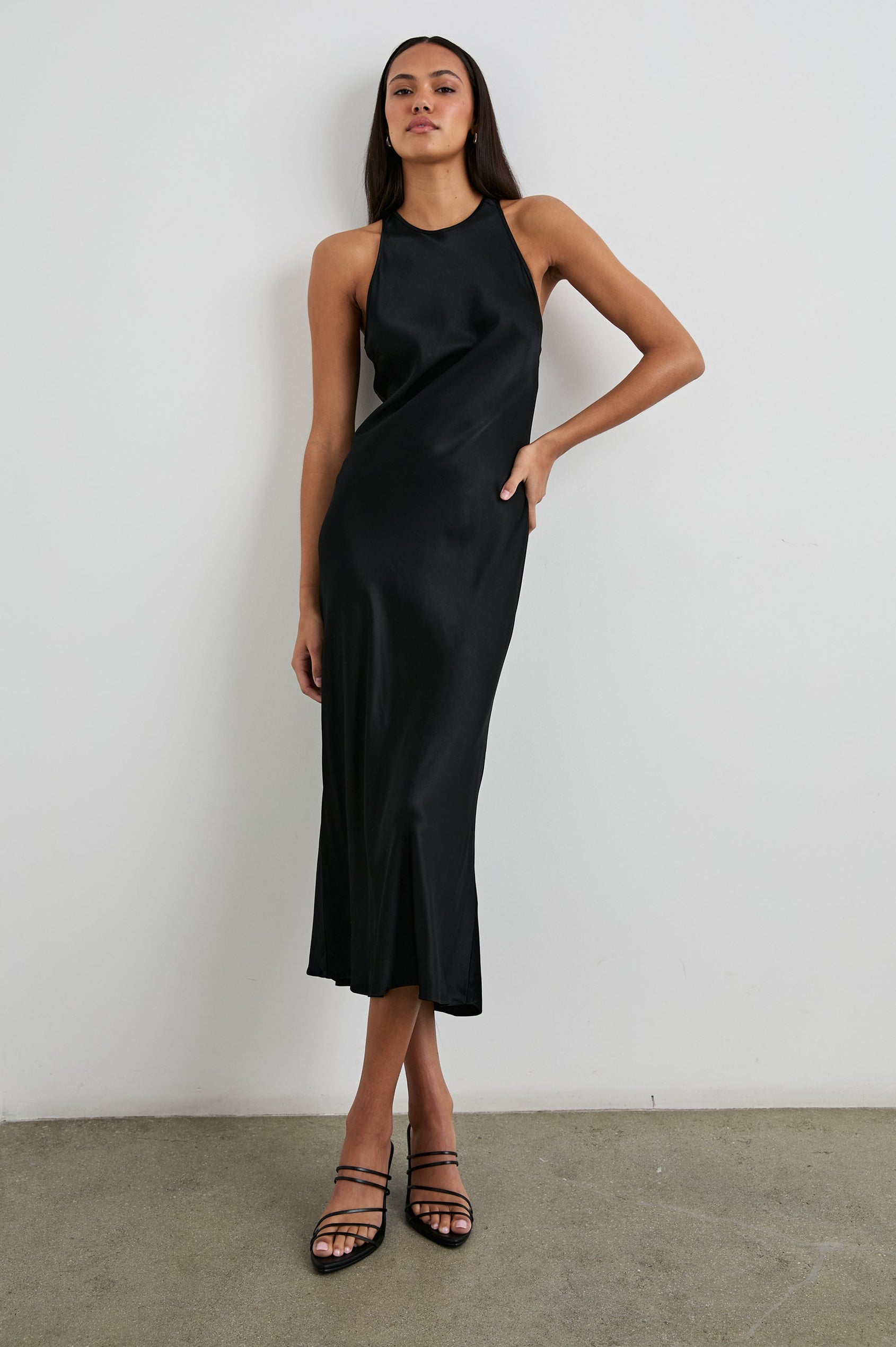 Solene Sleeveless Midi Dress with a Crew Neck and a Tie Keyhole at the Back in Black Colorway - Front Full Body View Featured on Model