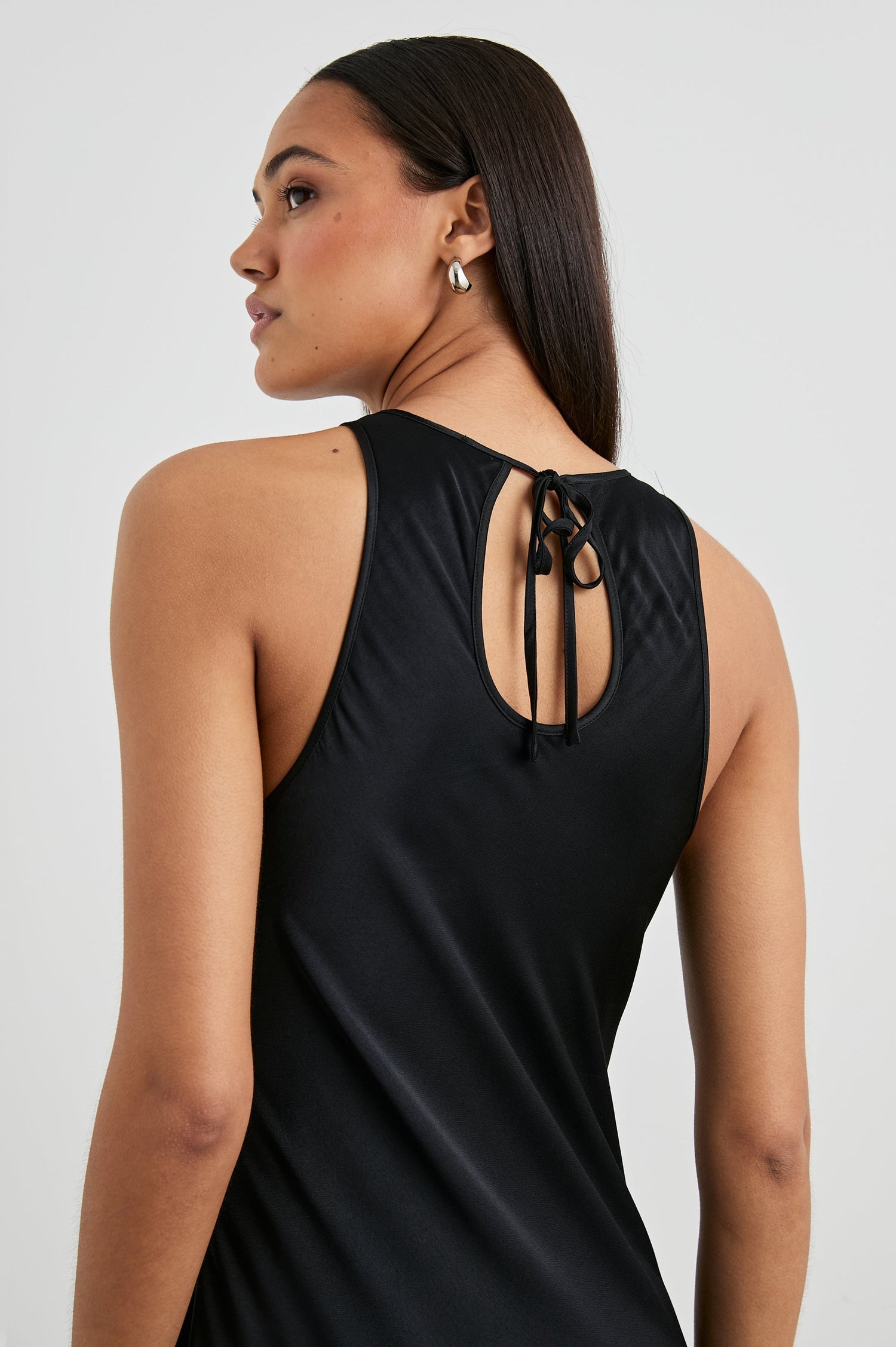 Solene Sleeveless Midi Dress with a Crew Neck and a Tie Keyhole at the Back in Black Colorway - Back View Featured on Model
