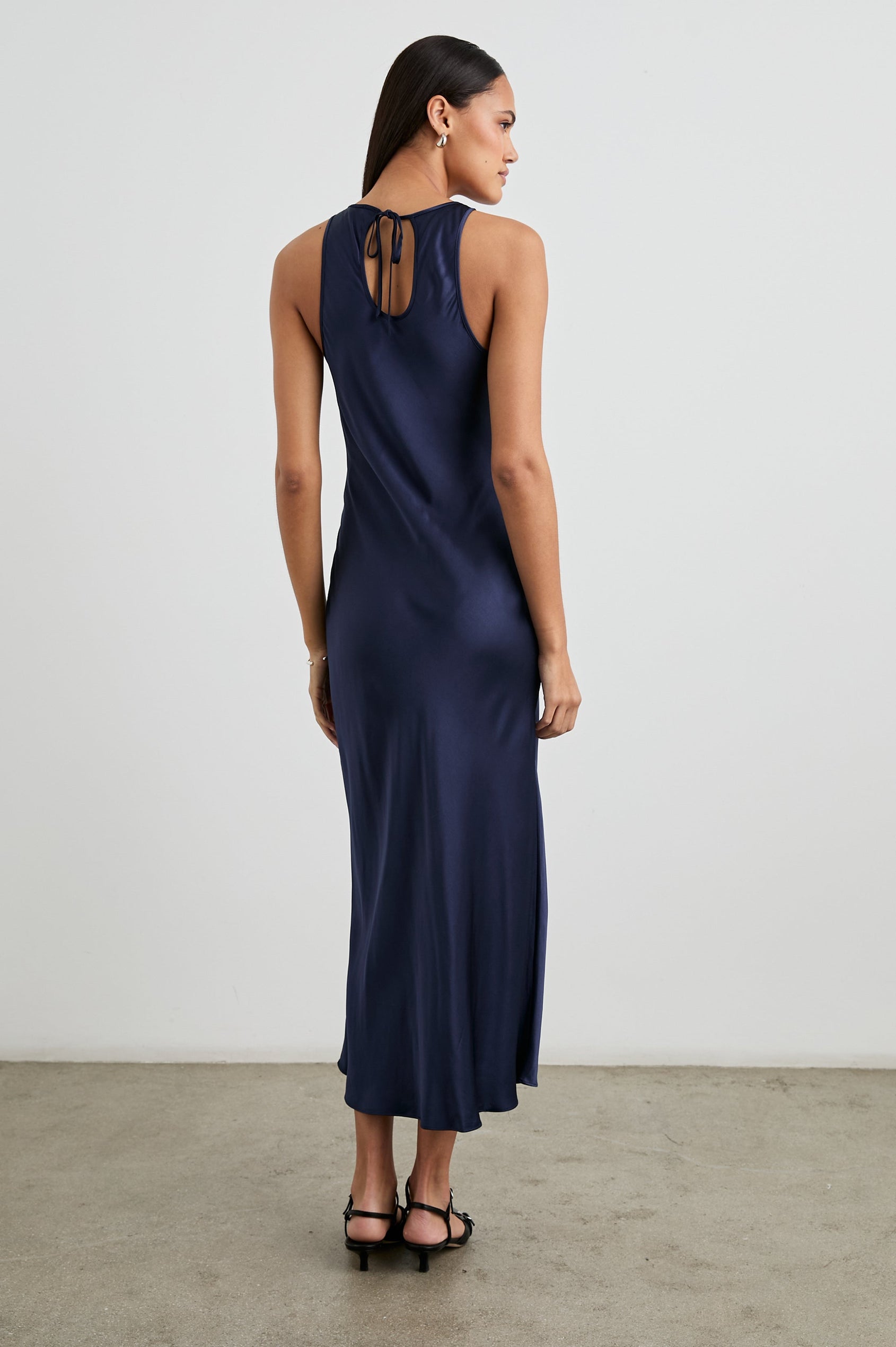Solene Sleeveless Midi Dress with a Crew Neck and a Tie Keyhole at the Back in Navy Colorway - Back Full Body View Featured on Model