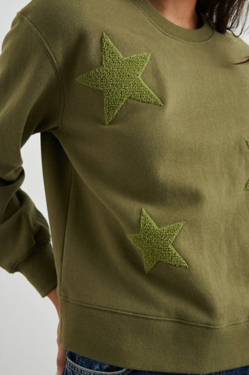 Sonia Long-Sleeve Sweatshirt with a Crew Neck and Patch Stars in Olive Colorway, with stars in a lighter shade - Front View Featured on Model