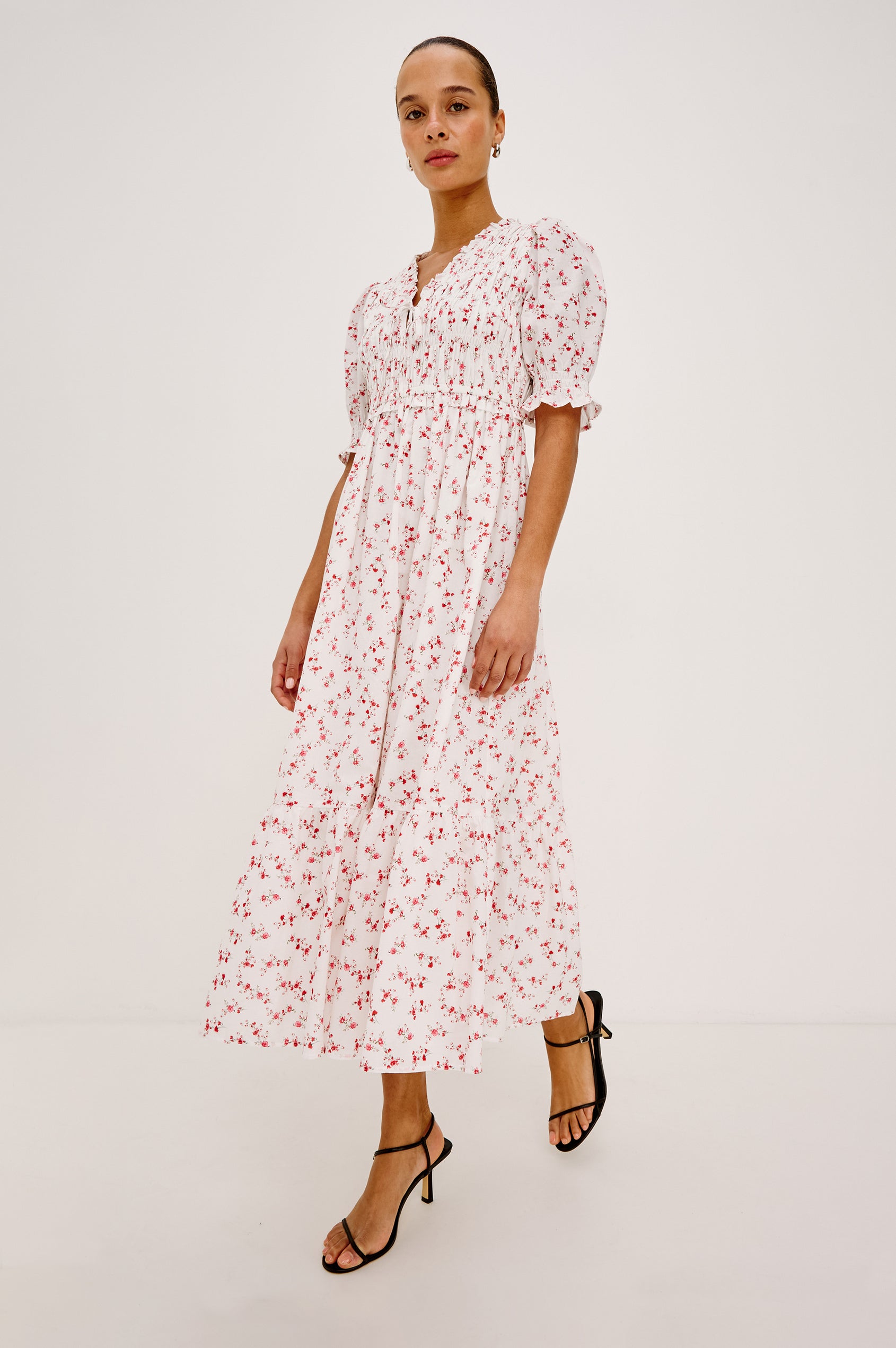 Sonica Midi Dress in Cotton With Fitted Smocked Bodice Plunging V-Neckline With Self-Ties Short Puff Sleeves and Single Tiered A-Line Skirt in Rouge Romantic Colorway - Upper Body Close Up View Featured on Model