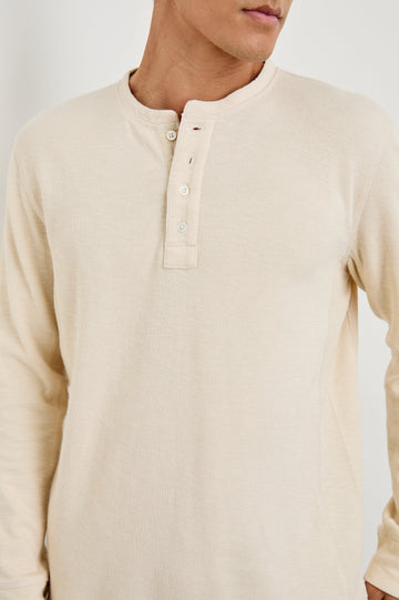 Soto Long-Sleeve Henley with a Four Button Placket and a Crew Neck in Bone Colorway - Front View Featured on Model