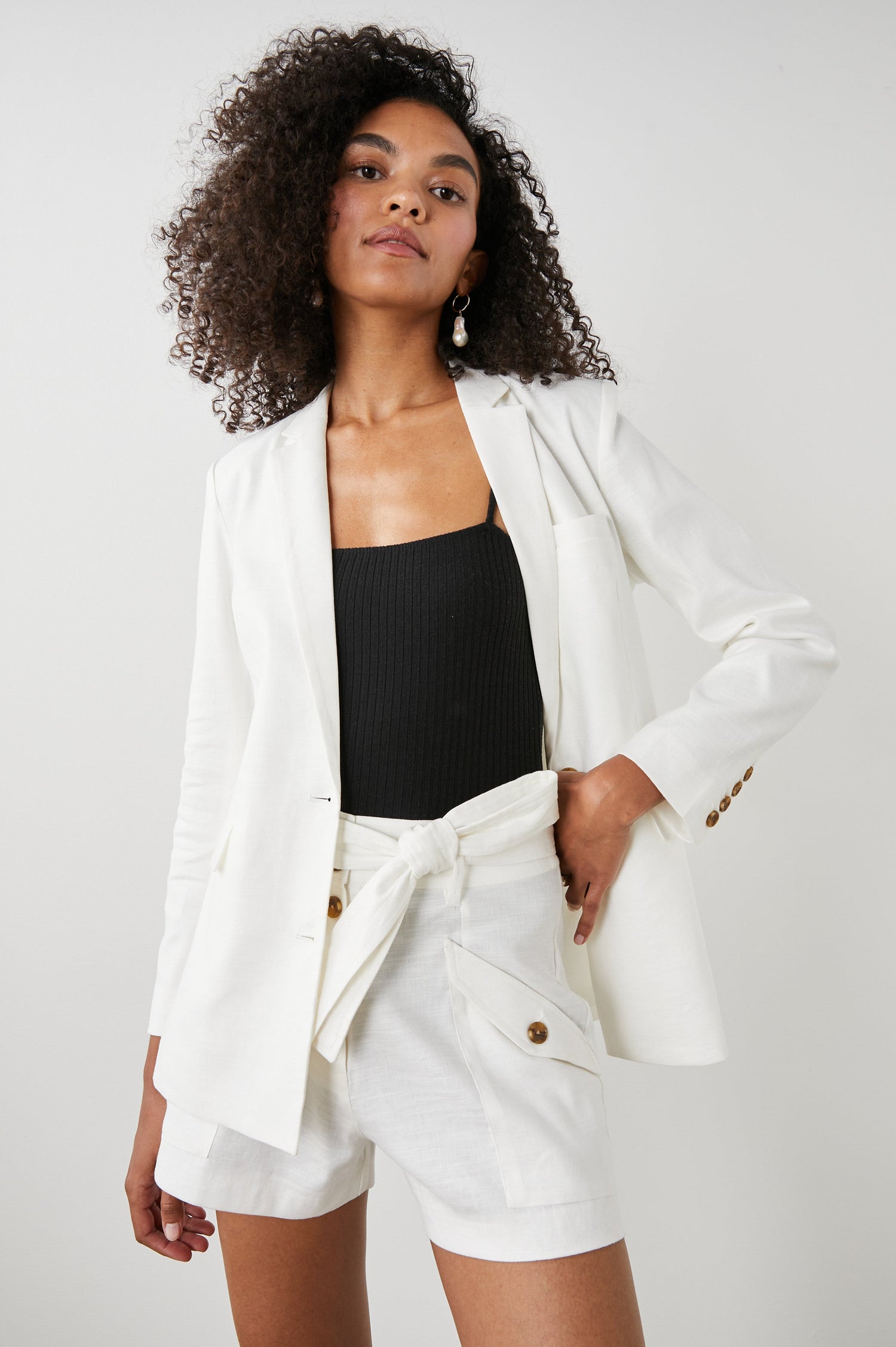 Stanton Blazer with Two Button Closure, Two Front Flap Pockets, a Chest Patch Pocket and Four-Button Cuffs in Creme Colorway - Front View Featured on Model