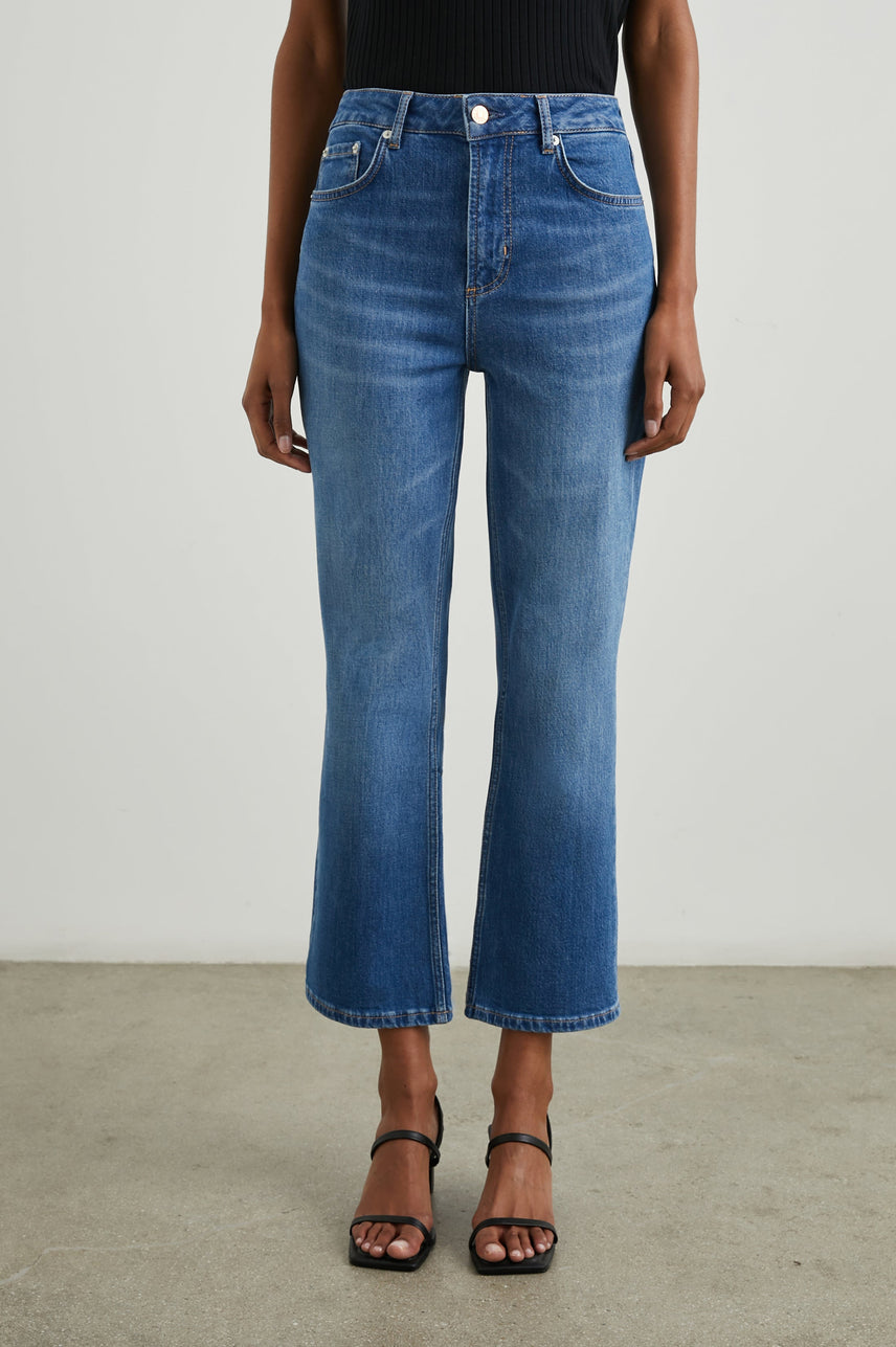 Sunset Crop Slim Fare Jeans with Belt Loops, Two Front Pockets plus a Coin Pocket and Two Back Patch Pockets in Tidal Wave Colorway - Front View Featured on Model