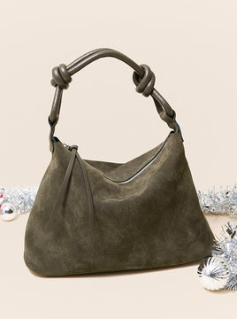 Image of an olive green suede handbag with christmas decor