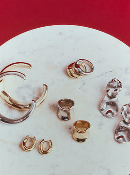 Variety of Different toned jewelry placed on a textured background
