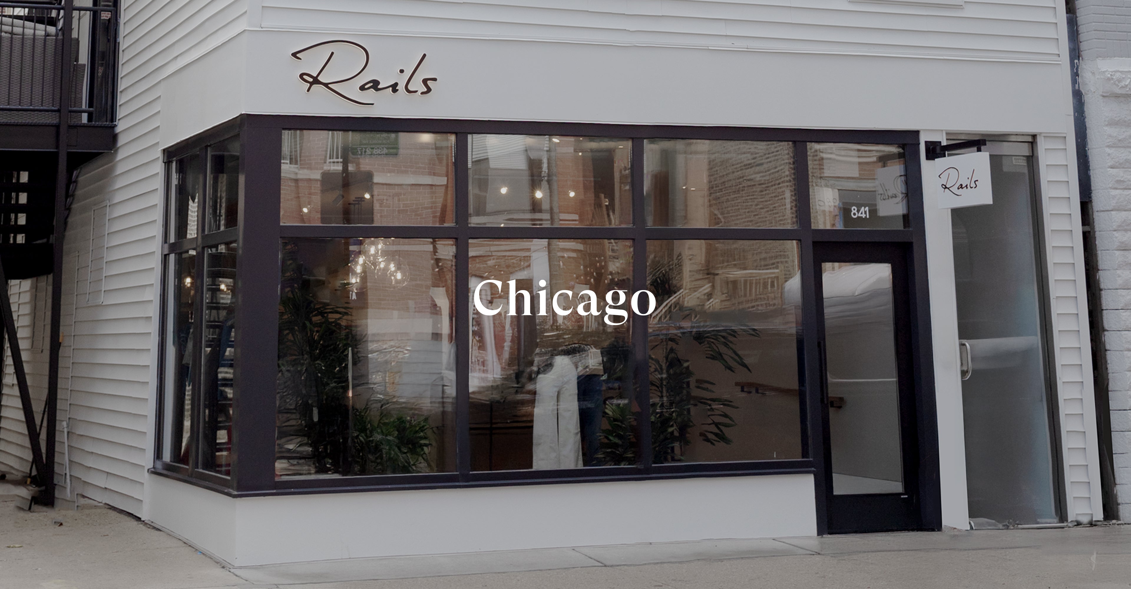 OUTSIDE OF FRONT OF RAILS CHICAGO RETAIL STORE SHOWING LARGE FRONT WINDOW