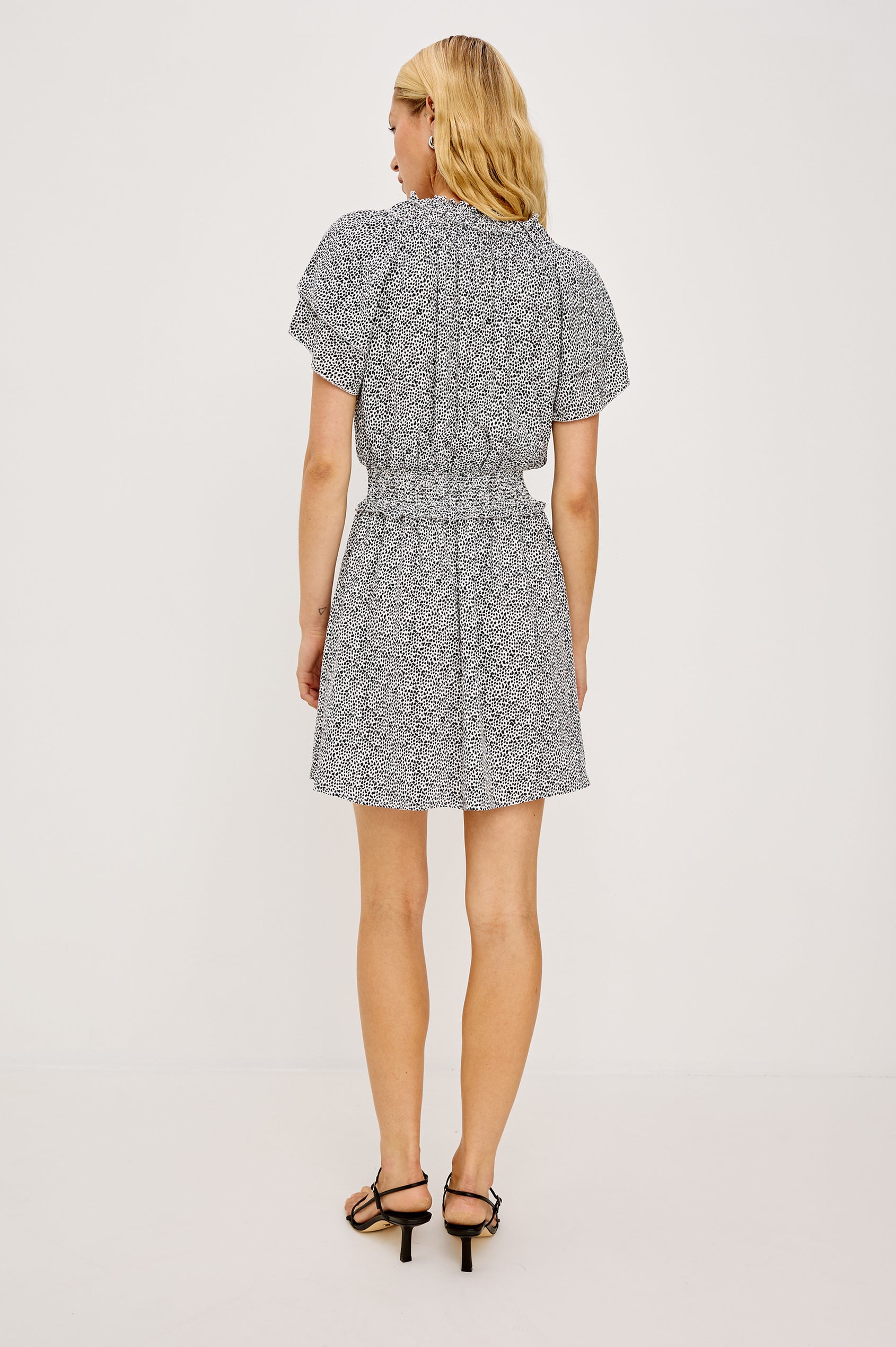 Terrin Mini Dress With Shirred Yoke V-Neckline Tiered Short Sleeves Smocked Waist and Fully Lined Skirt in Ivory Micro Spots Colorway - Full Body Back View Featured on Model