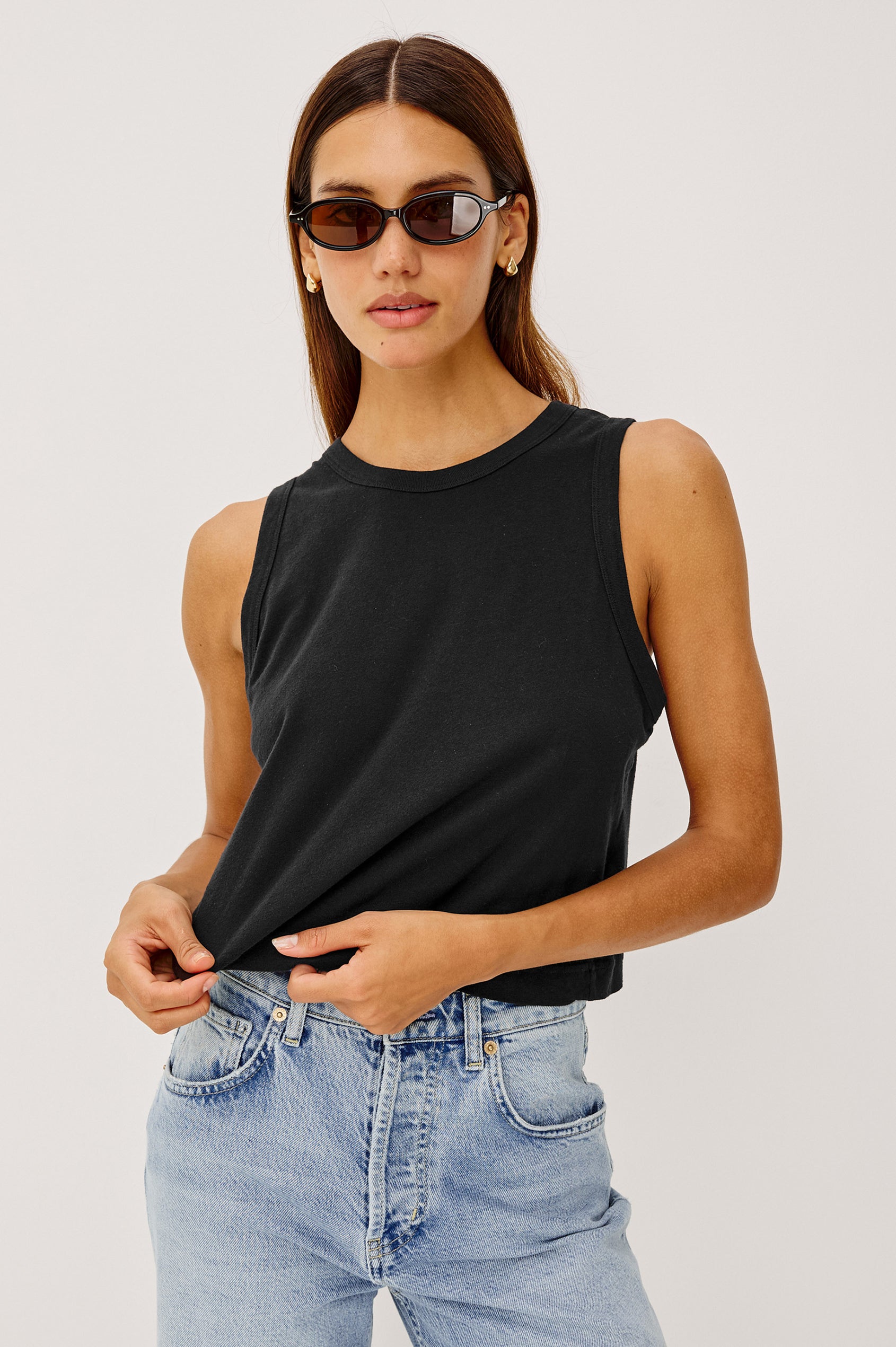 The Boxy Tank in 100% Cotton With Crew Neckline, Wide Shoulder Straps, and a Cropped, Boxy Fit in Black Colorway - Upper Body Front View Featured on Model