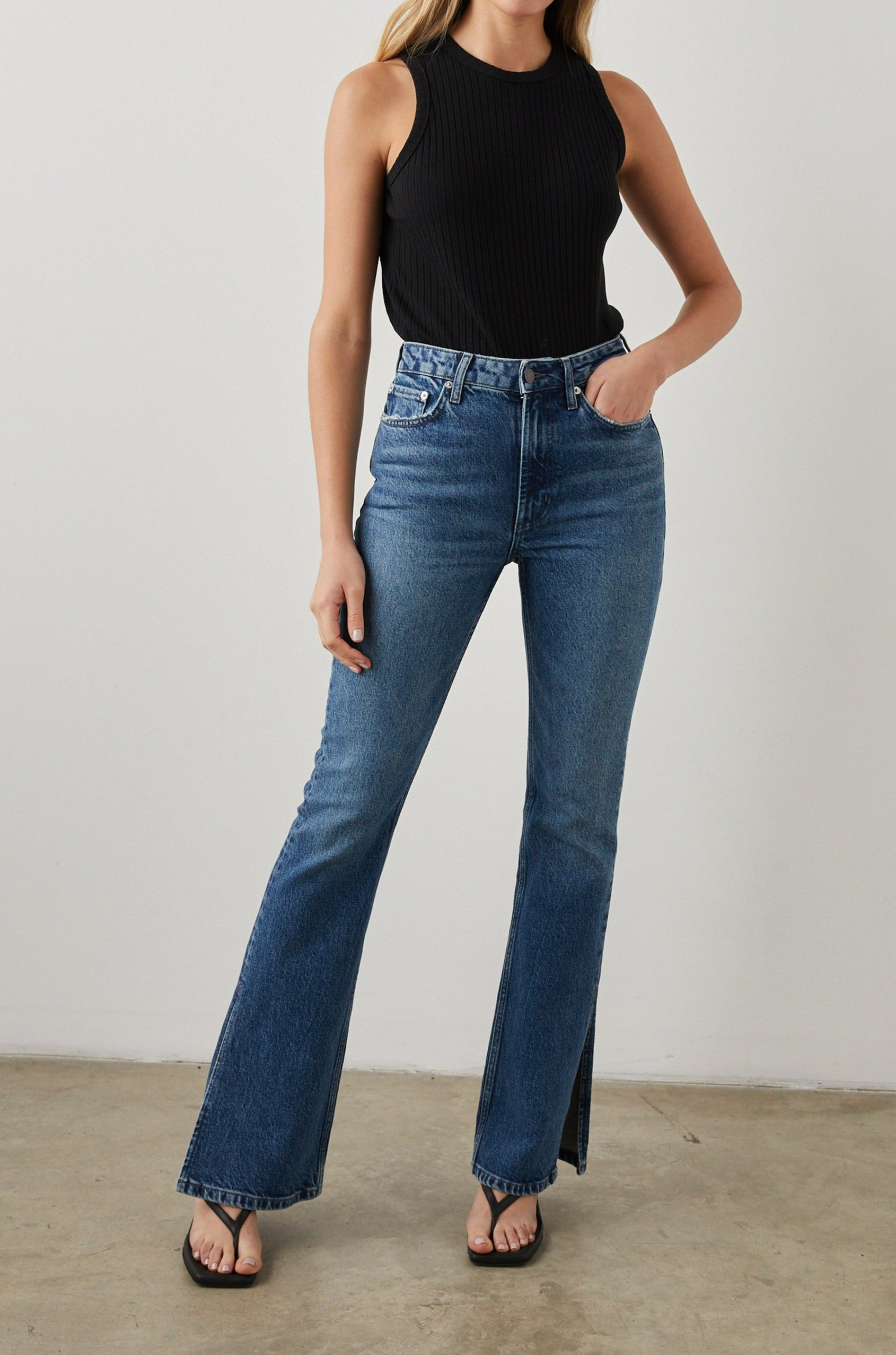Sunset Crop Slim Fare Jeans with Outer Hem Slits, Belt Loops, Two Front Pockets plus a Coin Pocket and Two Back Patch Pockets in Navy Stone Colorway - Front Full Body View Featured on Model