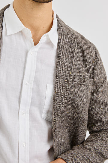 Reynard Blazer with Two Button Closure, Two Front Pockets, a Chest Welt Pocket, Herringbone Fabric in Highland Tweed Colorway, a Brown - Front View Featured on Model