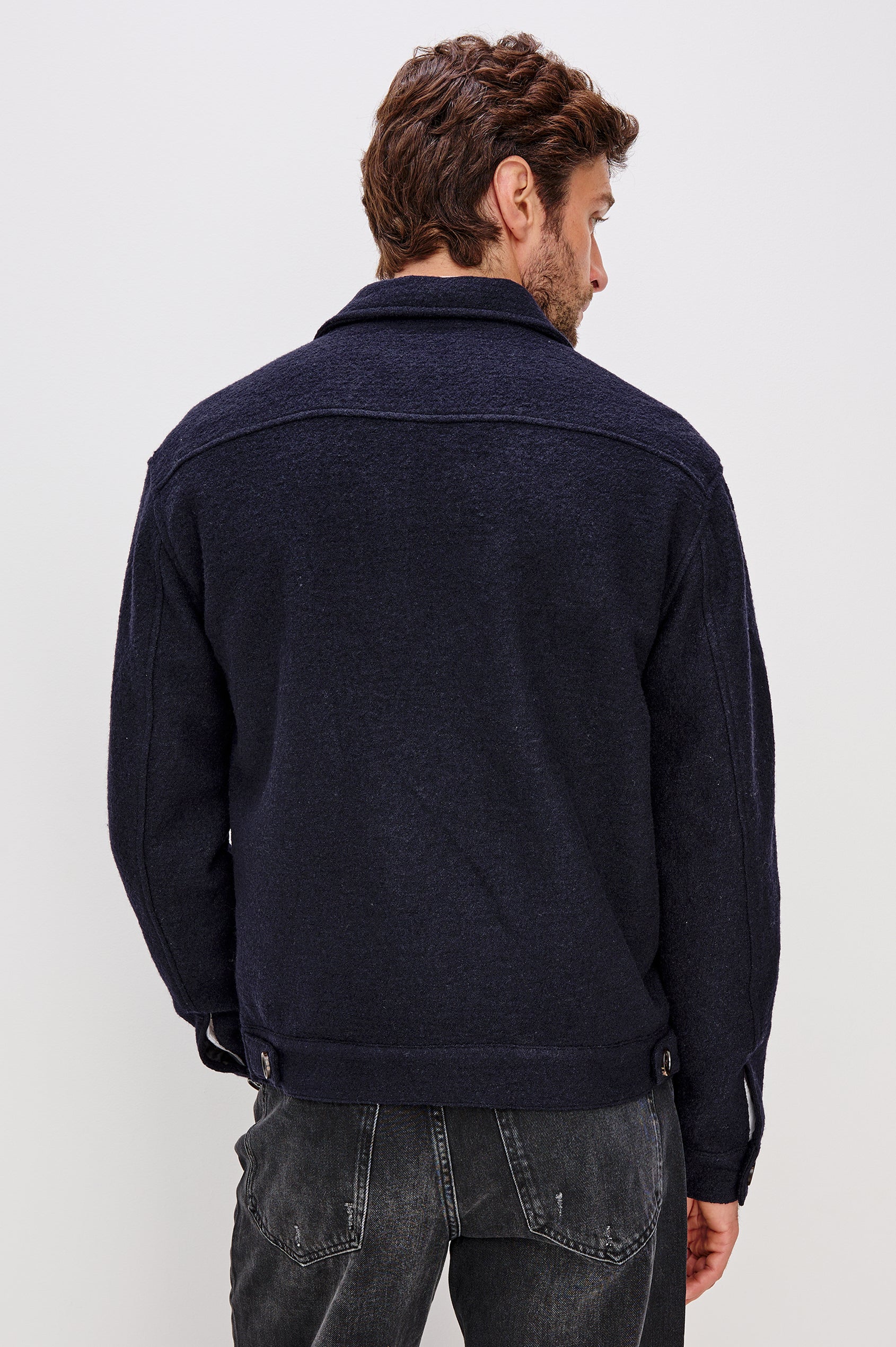 Tilman is a classic collar, front zip jacket, buttoned pockets with top and side entry in Navy Boucle colorway. Back view featured on model.