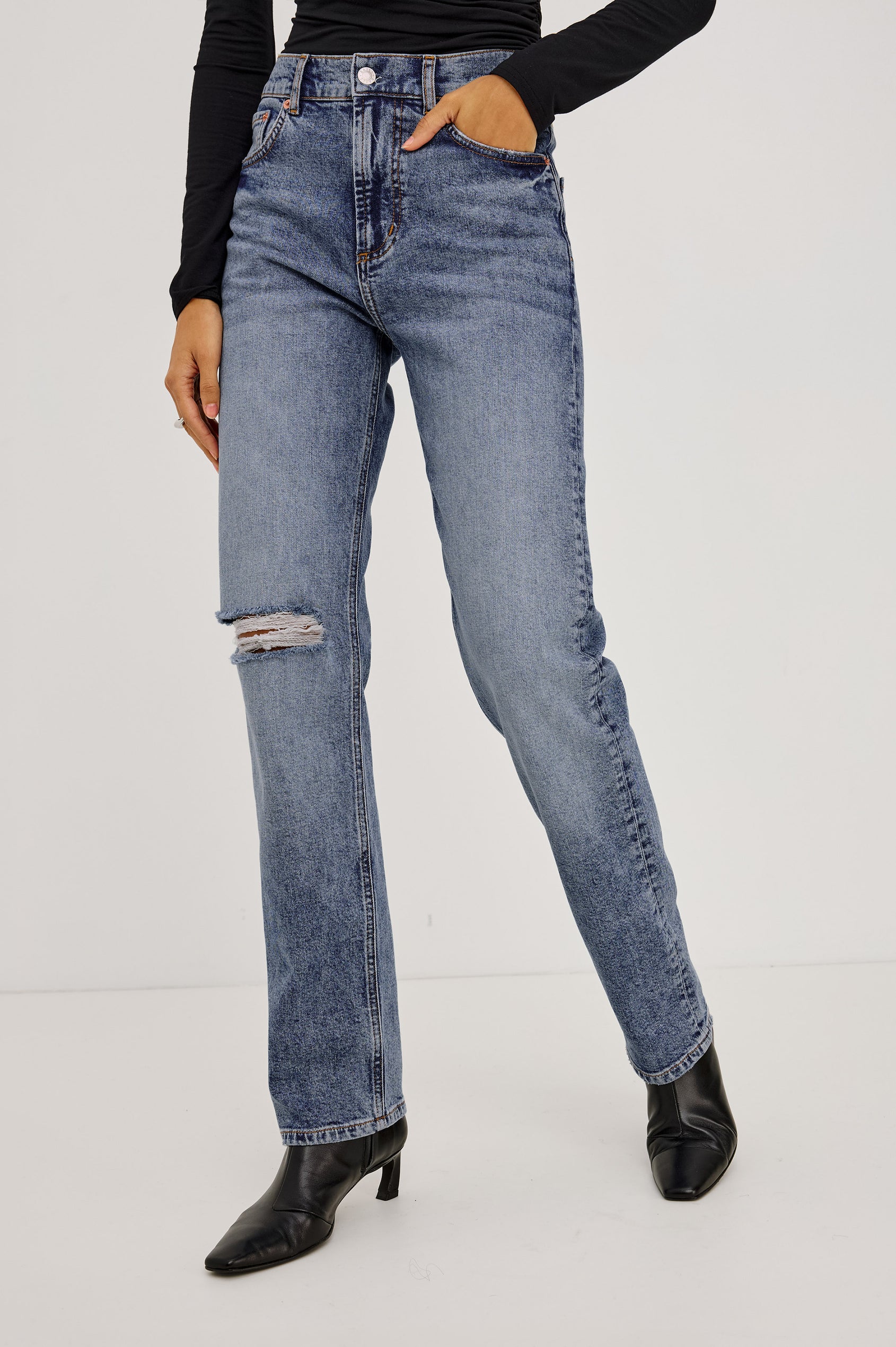 Topanga Straight Jean in Comfort-Stretch Denim With High-Rise, Distressed Knee, 5-Pockets, and Zipper Fly in Rancher Deconstructed Colorway - Lower Body Front View Featured on Model