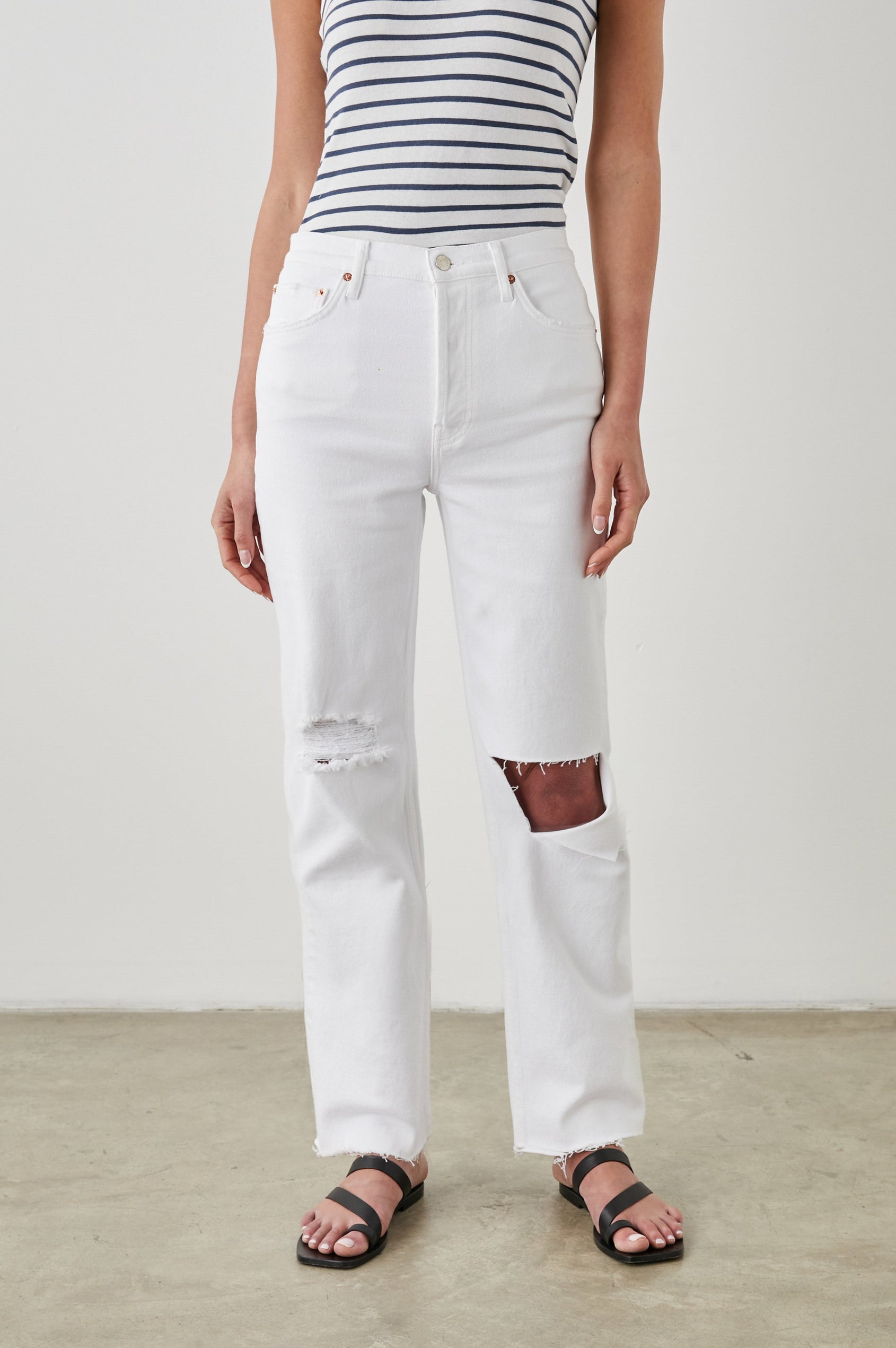 Topanga Straight Jeans with a Hole at the Knee and Fraying, Belt Loops, Two Front Pockets plus a Coin Pocket and Two Back Patch Pockets in Salt White Distress Colorway - Front View Featured on Model