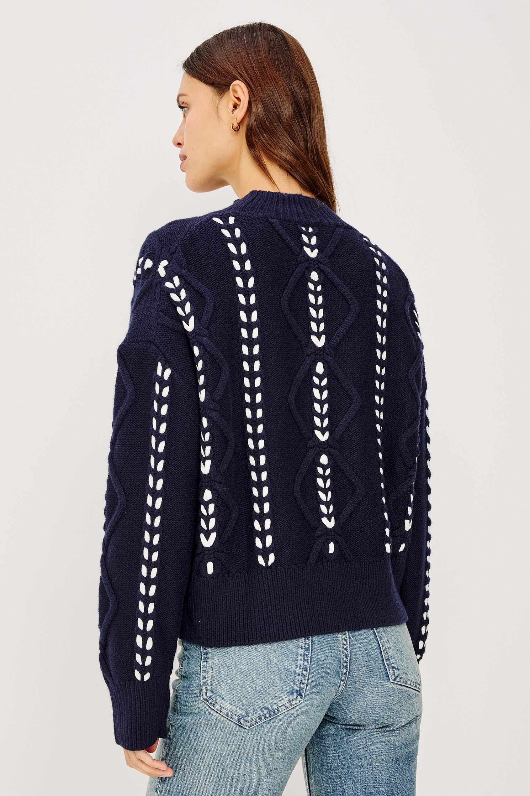 Tori Sweater in Wool Blend Cable Knit With Contrast Ribbon Stitching, a Ribbed Mock Neckline, Long Sleeves, and a Boxy Fit in Midnight Colorway - Upper Body Front View Featured on Model
