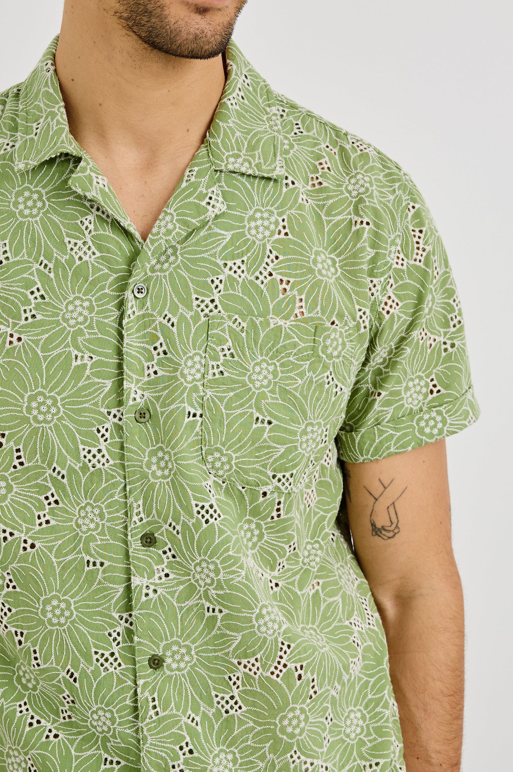 Tyler Collared Button Front Shirt with Short Sleeves and a Chest Pocket in Green White Sunflower Colorway. Front Detail View Shown on Model.
