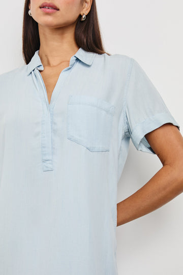 Valerie Short-Sleeve Denim Mini Dress with Rolled Cuffs, a Collar, a Half Sealed Placket, a Chest Pocket and a Raw Hem in Light Vintage Colorway - Front View Featured on Model 