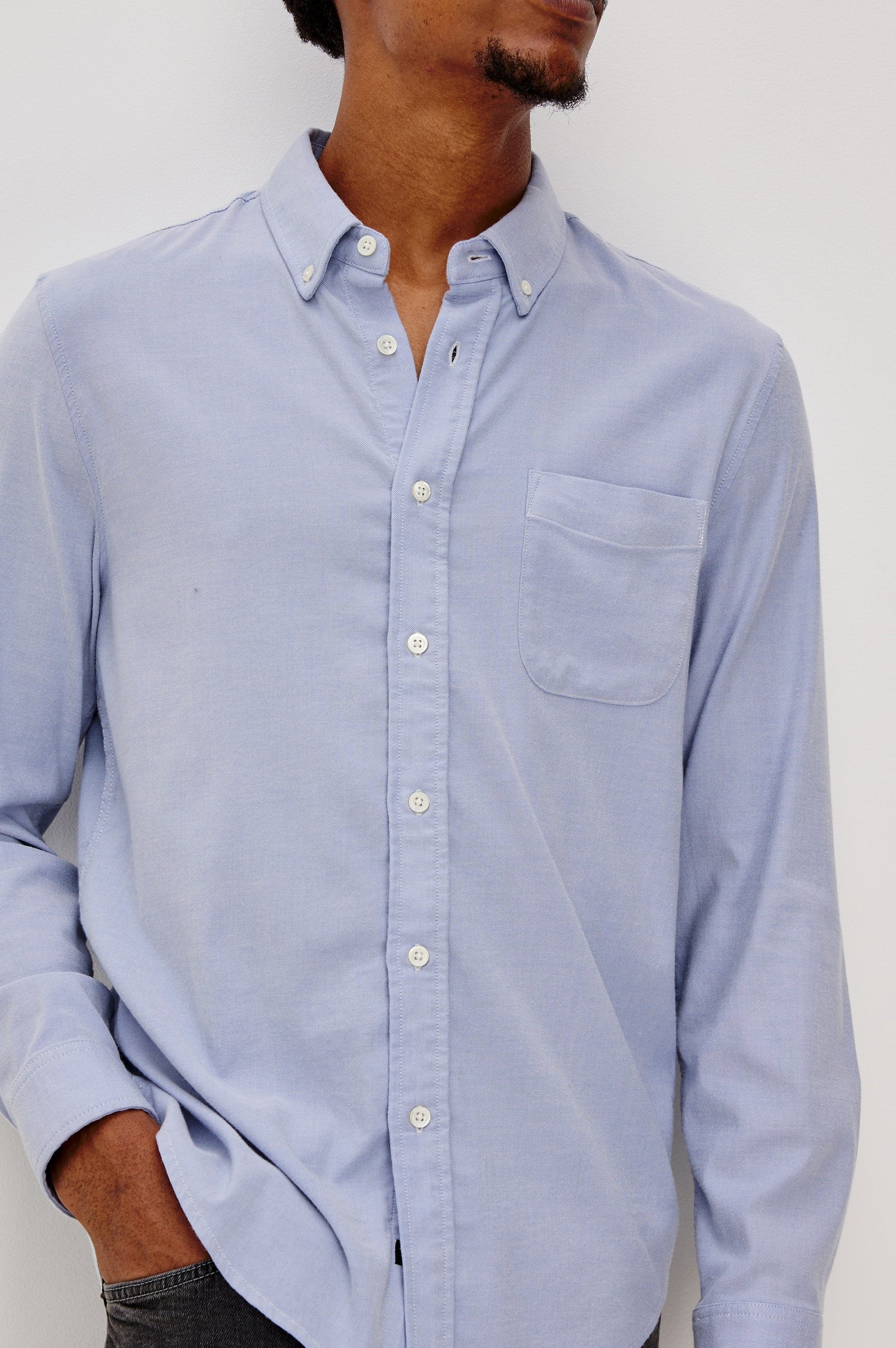 Vance button front collared shirt with long sleeves, collard stand buttons and a single chest pocket in Blue Oxford colorway. Front detail view shown on model.