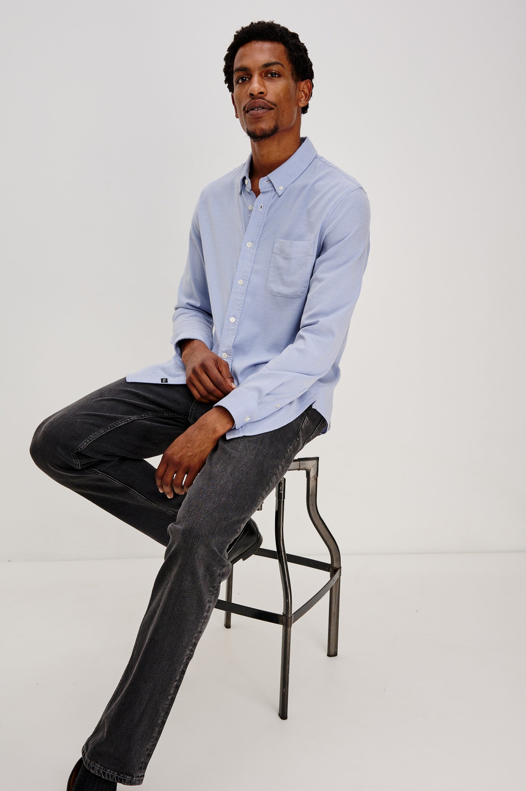 Vance button front collared shirt with long sleeves, collard stand buttons and a single chest pocket in Blue Oxford colorway. Front view shown on model.