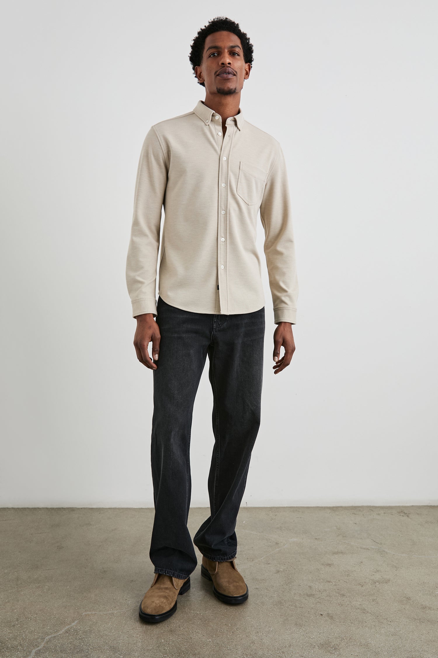 Vincent long sleeve shirt combines comfort of a knit with a buttoned classic collar. Front view of model feautured.