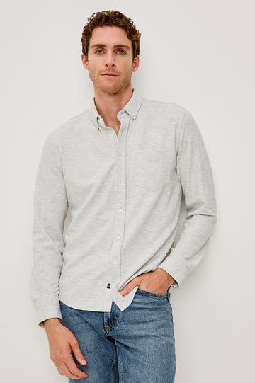 Vincent is a collared long sleeve button front shirt with a chest pocket in Heather Grey colorway. Front view featured on model.