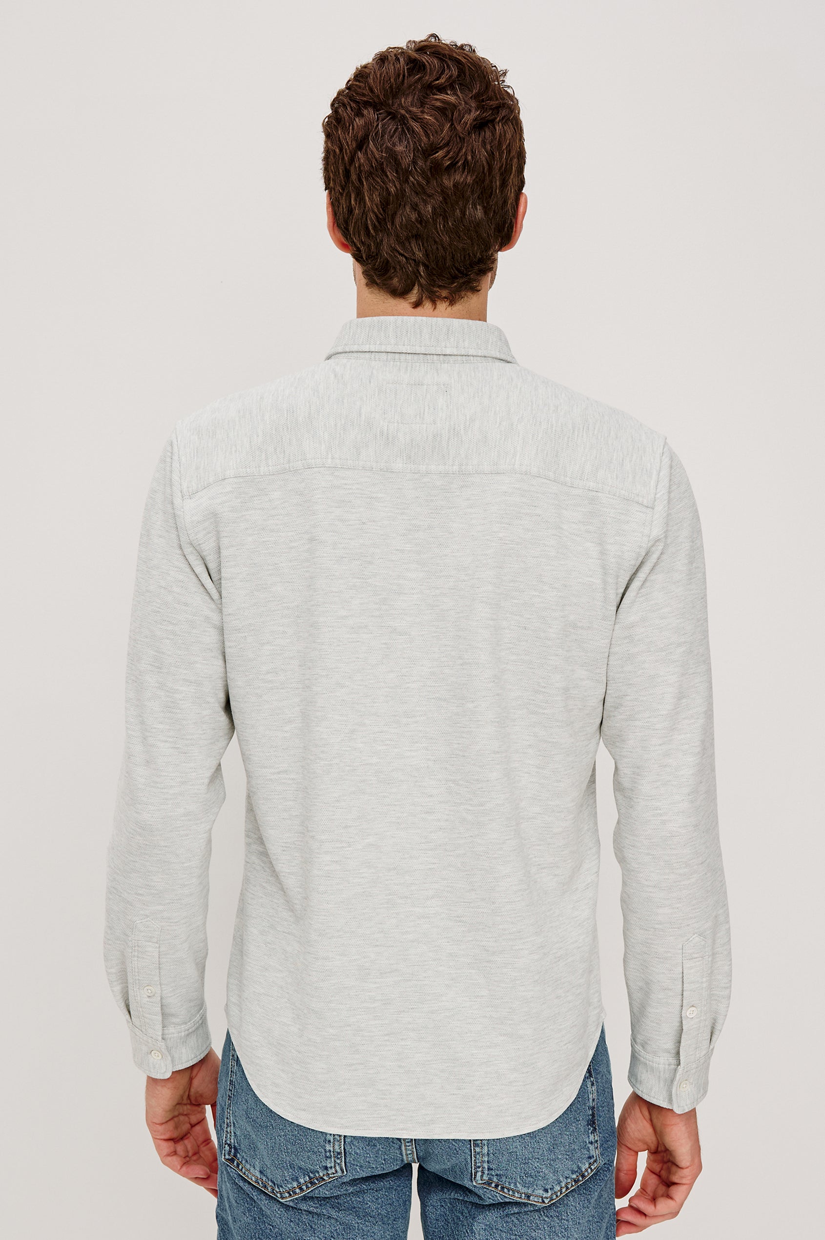 Vincent is a collared long sleeve button front shirt with a chest pocket in Heather Grey colorway. Back view featured on model.