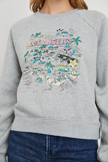 Vintage Raglan Long-Sleeve Sweatshirt with a Crew Neck, an image of landmarks in Los Angeles and the Text, Rails Los Angeles in Rails Los Angeles Map Grey Colorway, Mostly Pink, Yellow and Blue on Grey - Front View Featured on Model