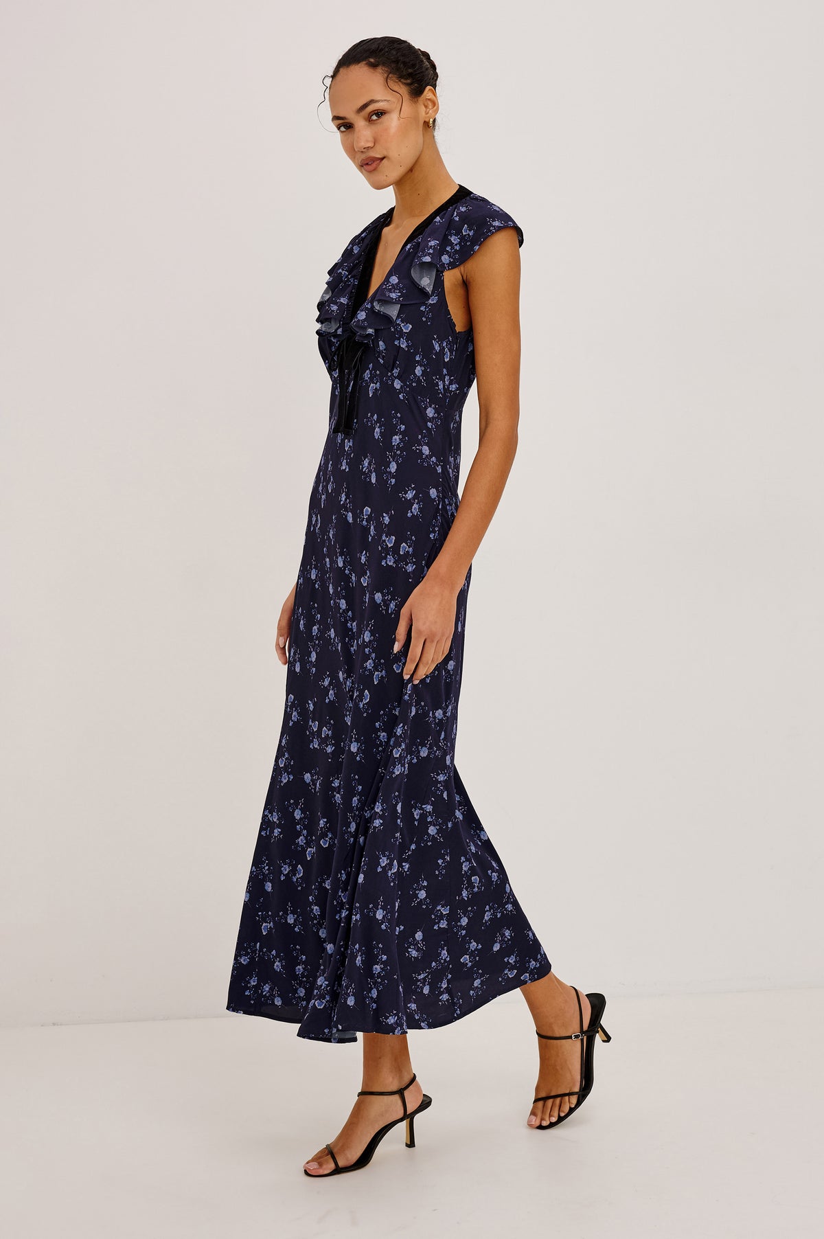 Virginia Maxi Dress in Lightweight Crepe With Ruffle-Trimmed Plunging V-Neckline With Center-Front Bow, Bias Cut, Side Zip Closure, and Godet Insets in Navy Romantic Floral Colorway - Upper Body Front View Featured on Model.