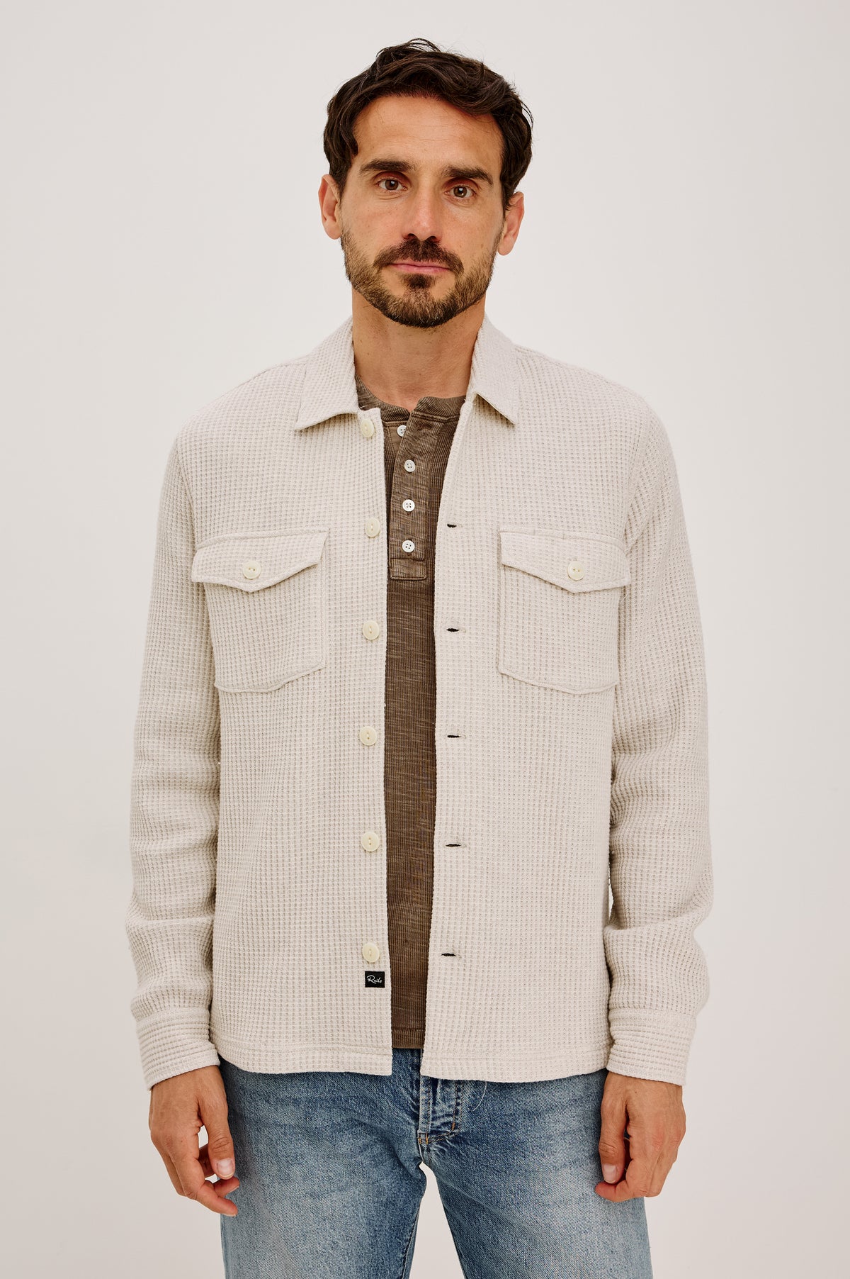 Wells Overshirt in Waffle Knit With Front Buttons, Chest Flap Pockets, Point Collar, and Long Sleeves in Oat Heather Colorway - Upper Body Front View Featured on Model.