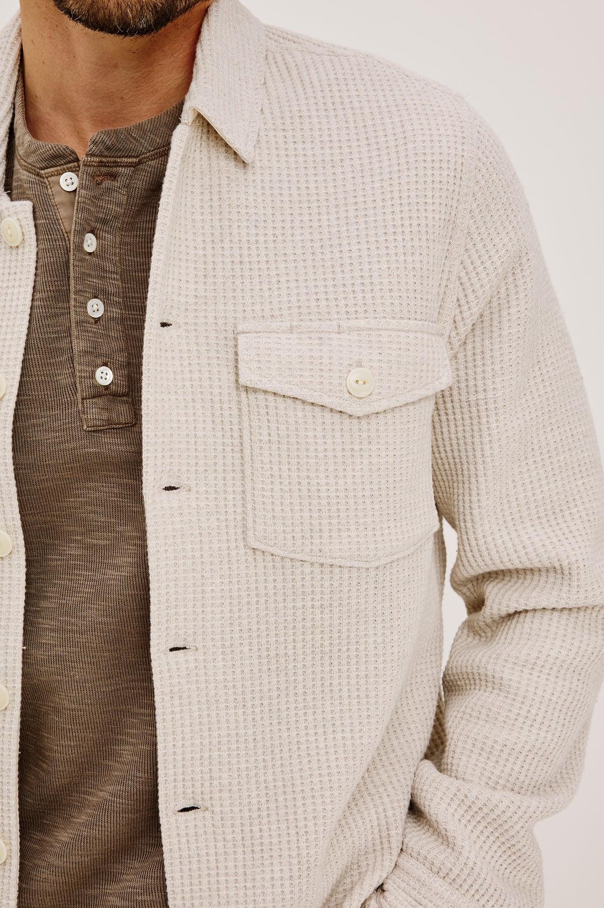 Wells Overshirt in Waffle Knit With Front Buttons, Chest Flap Pockets, Point Collar, and Long Sleeves in Oat Heather Colorway - Upper Body Front Detail View Featured on Model.