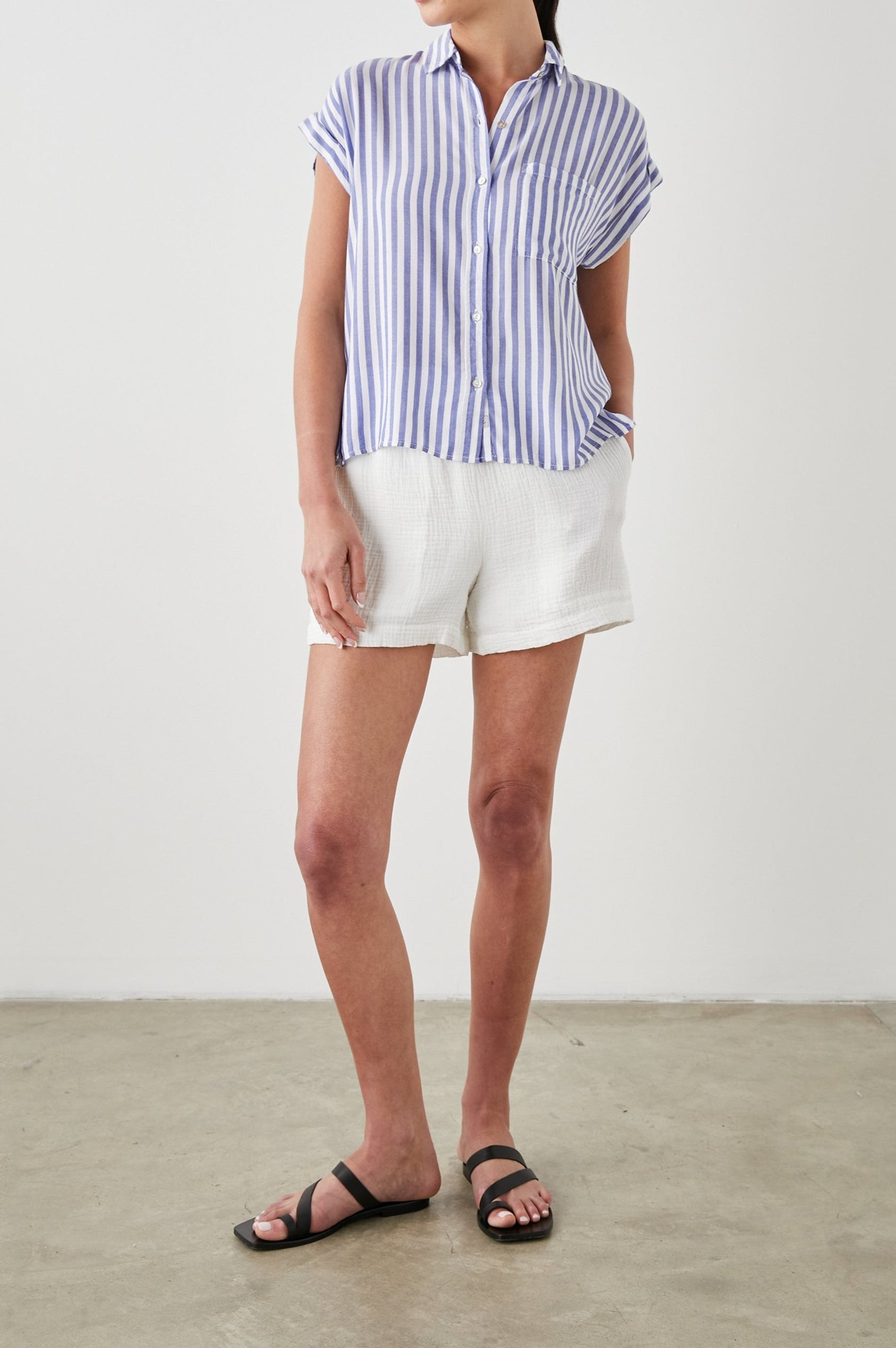 Whitney Short Rolled Sleeves Button Up with a Chest Patch Pocket and Short Side Slits in Blue White Stripe Colorway, with vertical stripes - Front Full Body View Featured on Model