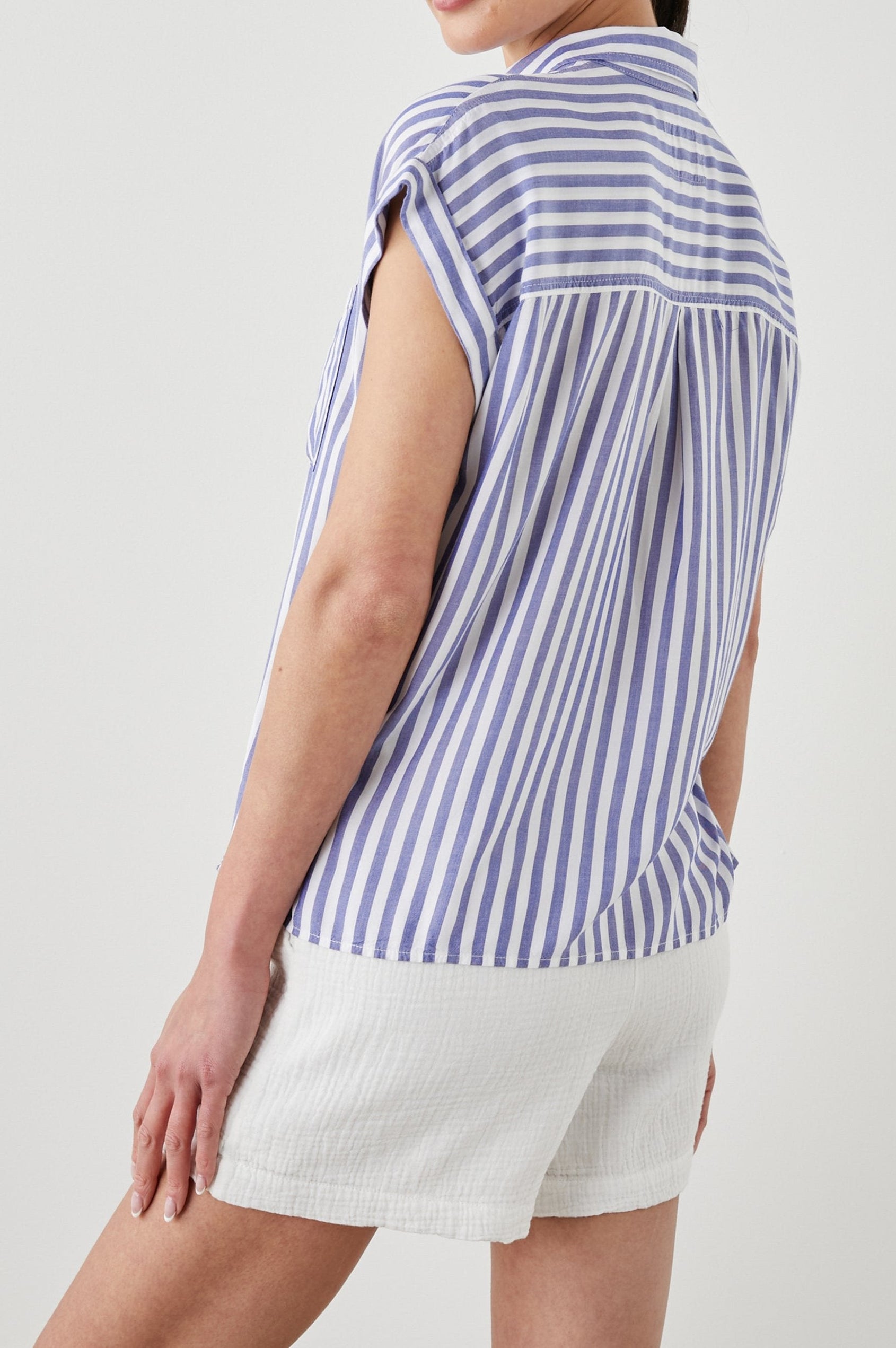 Whitney Short Rolled Sleeves Button Up with a Chest Patch Pocket and Short Side Slits in Blue White Stripe Colorway, with vertical stripes - Back View Featured on Model