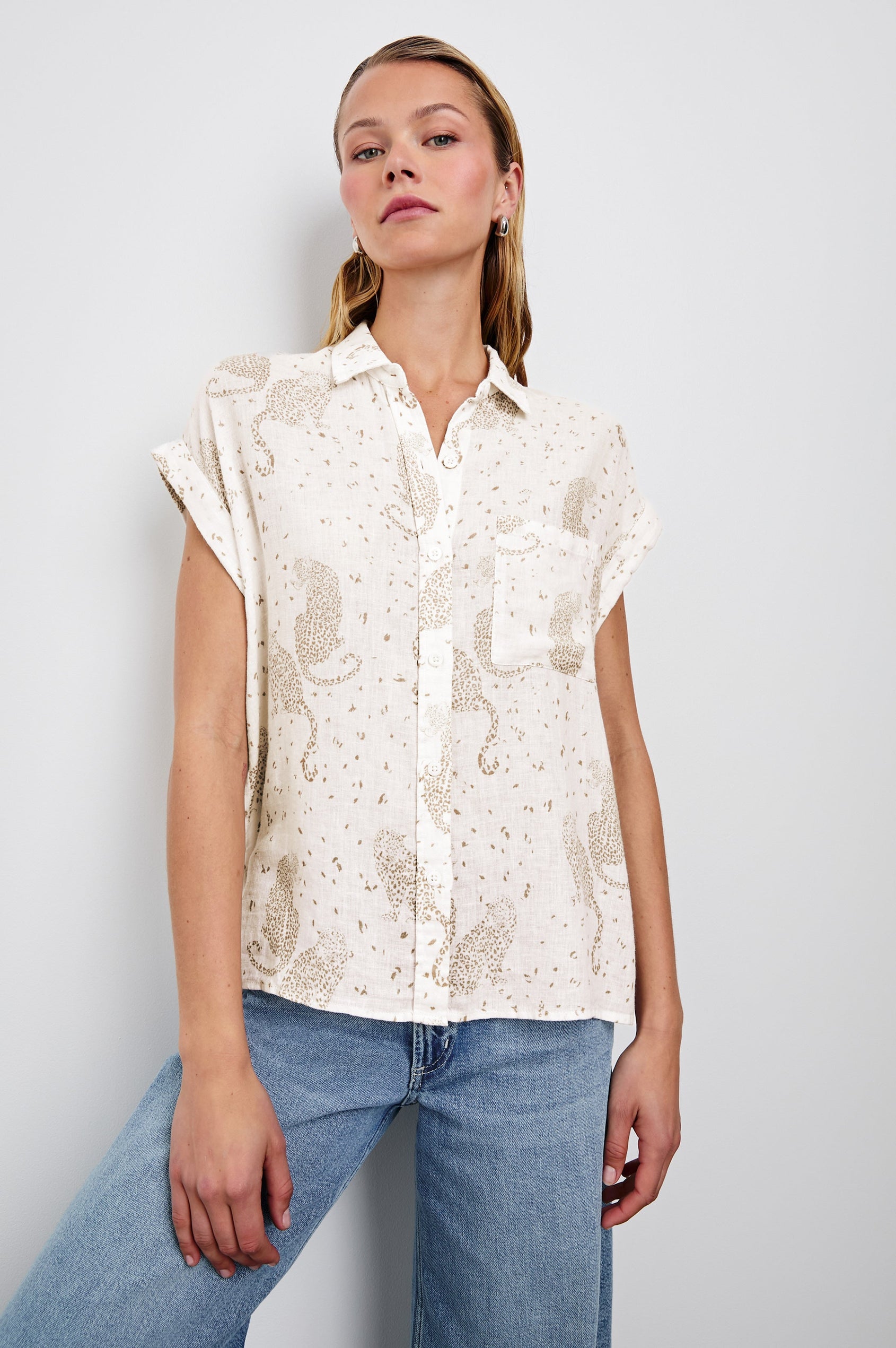 Whitney Short Rolled Sleeves Button Up with a Chest Patch Pocket and Short Side Slits in Cheetah Spots Colorway, with spots and cheetahs in brown on cream - Front View Featured on Model