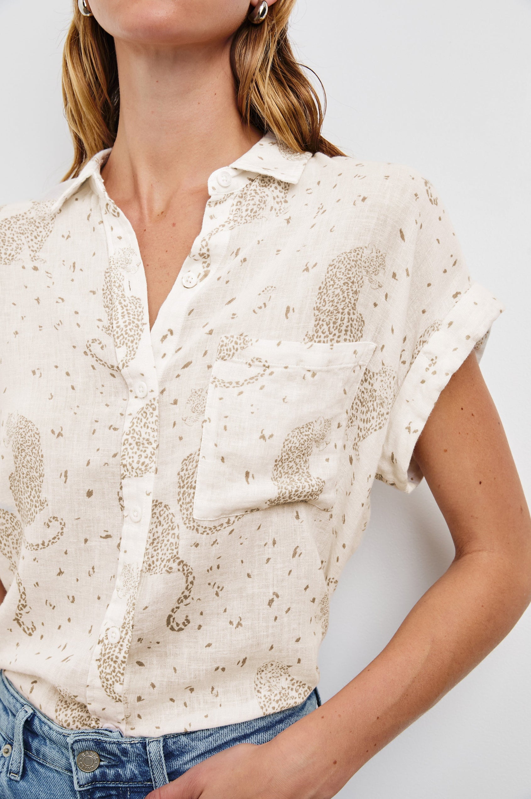 Whitney Short Rolled Sleeves Button Up with a Chest Patch Pocket and Short Side Slits in Cheetah Spots Colorway, with spots and cheetahs in brown on cream - Front Tucked View Featured on Model